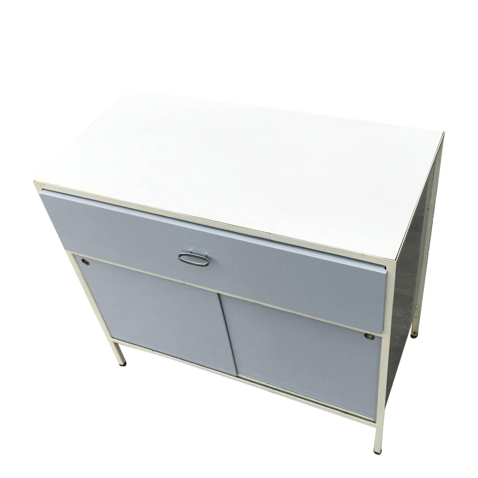 George Nelson Herman Miller steel cabinet in grey. The Cabinets doors, drawers, and side have been restored in grey lacquer. The back retains the original green color. Inside the drawer the label is intact. The white paint on the steel not in