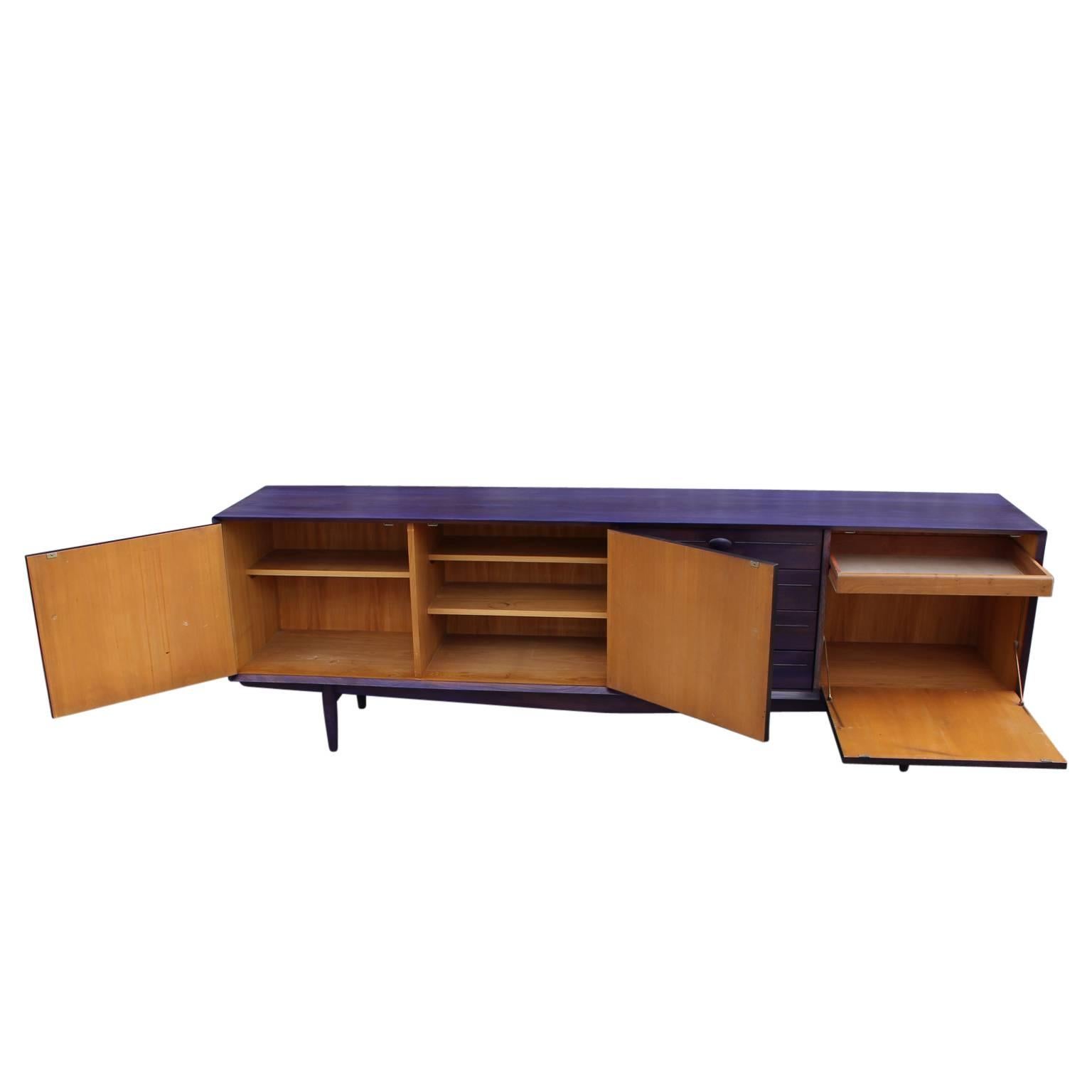 Beautiful purple aniline dyed modern credenza or sideboard with black detailing. 
Stunning from all angles. The sideboard  has three cabinet spaces and three drawers. The wood is made out of mahogany and birch made in the 1960s. 