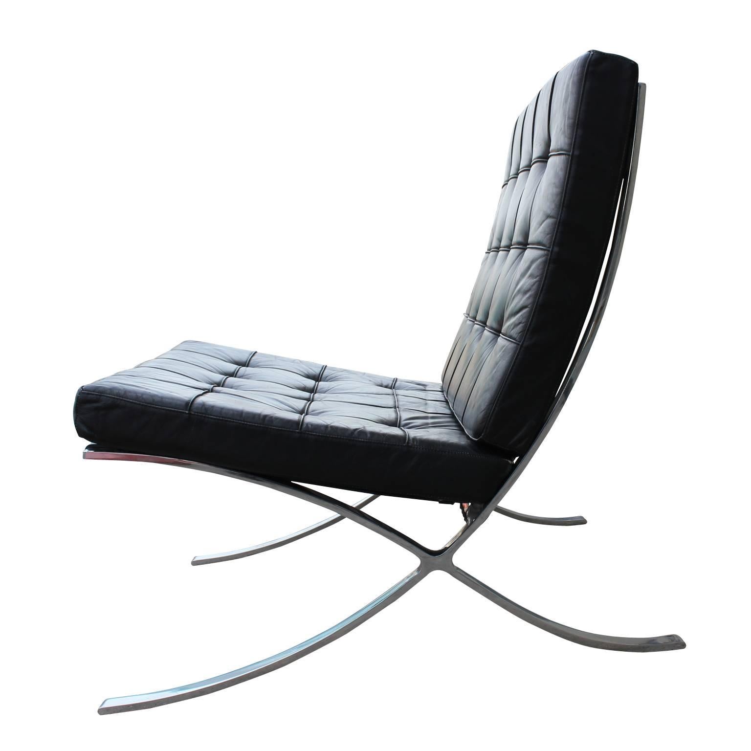 Modern Knoll-Inspired Barcelona chair in black leather and with a chrome frame. Has four buttons missing on the seat, but in otherwise great condition and a great addition to your living room or office, circa 1970s.