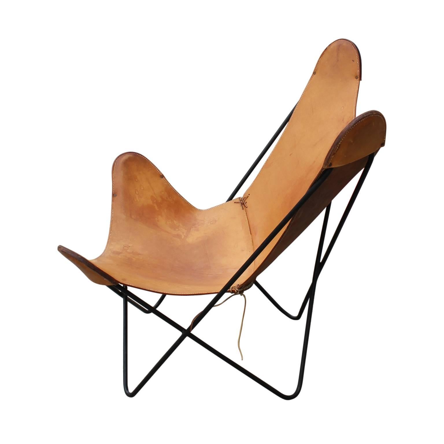 Gorgeous modern Knoll light brown leather butterfly chair with and iron frame.