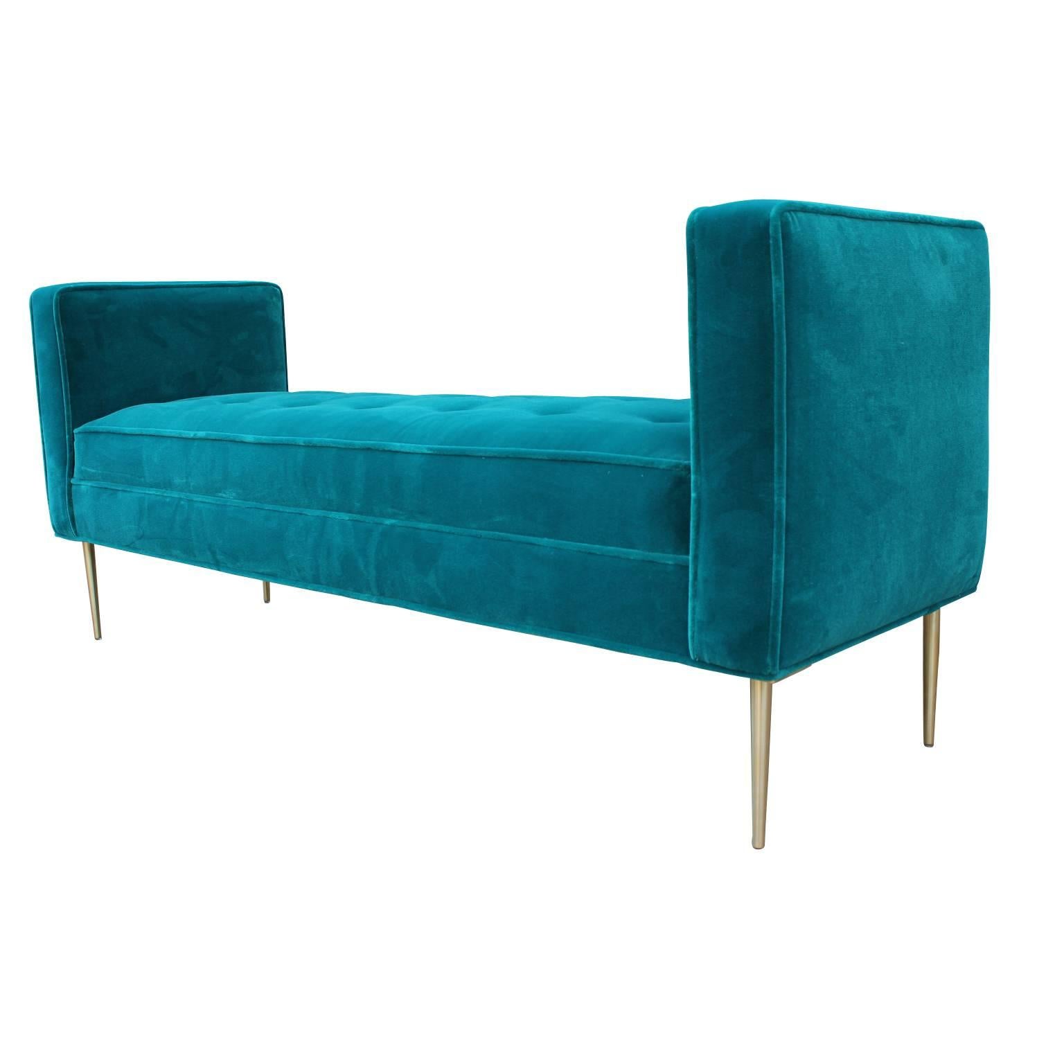 Beautiful armed bench upholstered in a luscious teal / turquoise velvet with brushed brass legs.