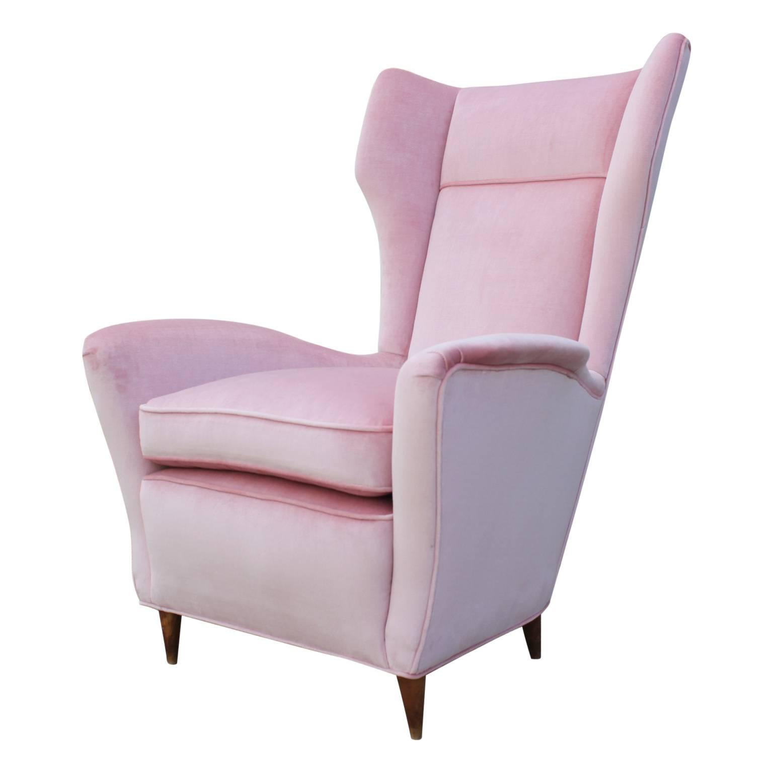 Recently reupholstered Italian wingback chairs in a gorgeous light pink velvet featuring light wood legs that are delicately tapered.