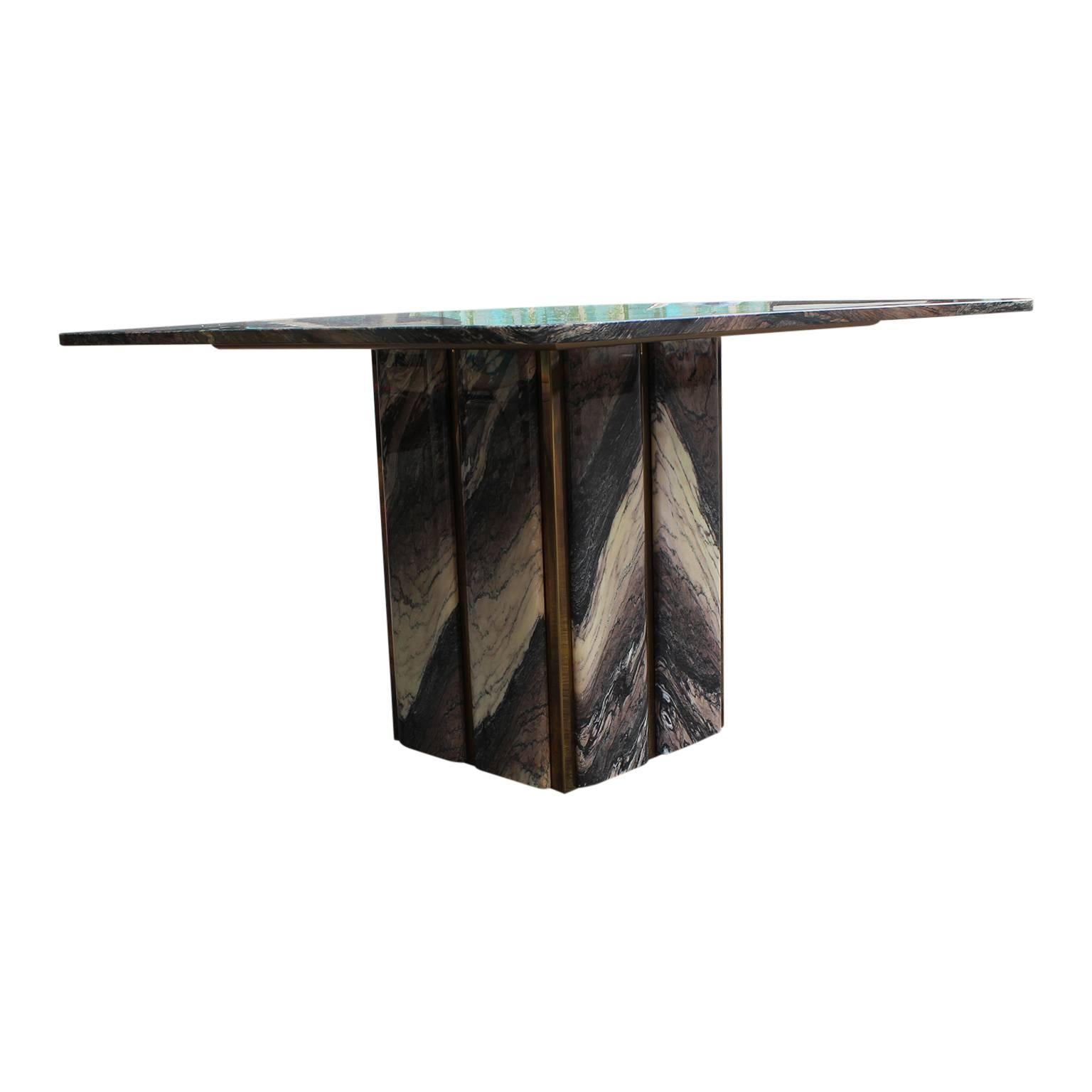 This is one of the most stunning tables we have seen. The cut of marble is out of this world! The base is trimmed in brass with marble in between. It is in excellent vintage condition with no real flaws to note. In the style of Romeo Rega.