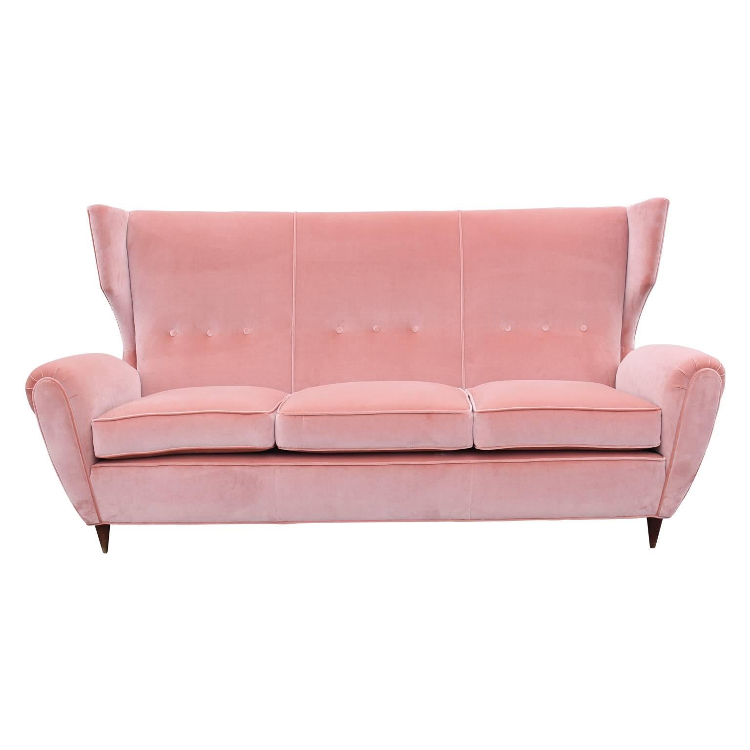 Gorgeous modern Italian wingback couch recently recovered in a lush light pink Kravet velvet with small tapered walnut legs. This three-seat would be a great statement piece and perfect for entertaining or in the entrance of any building!
 