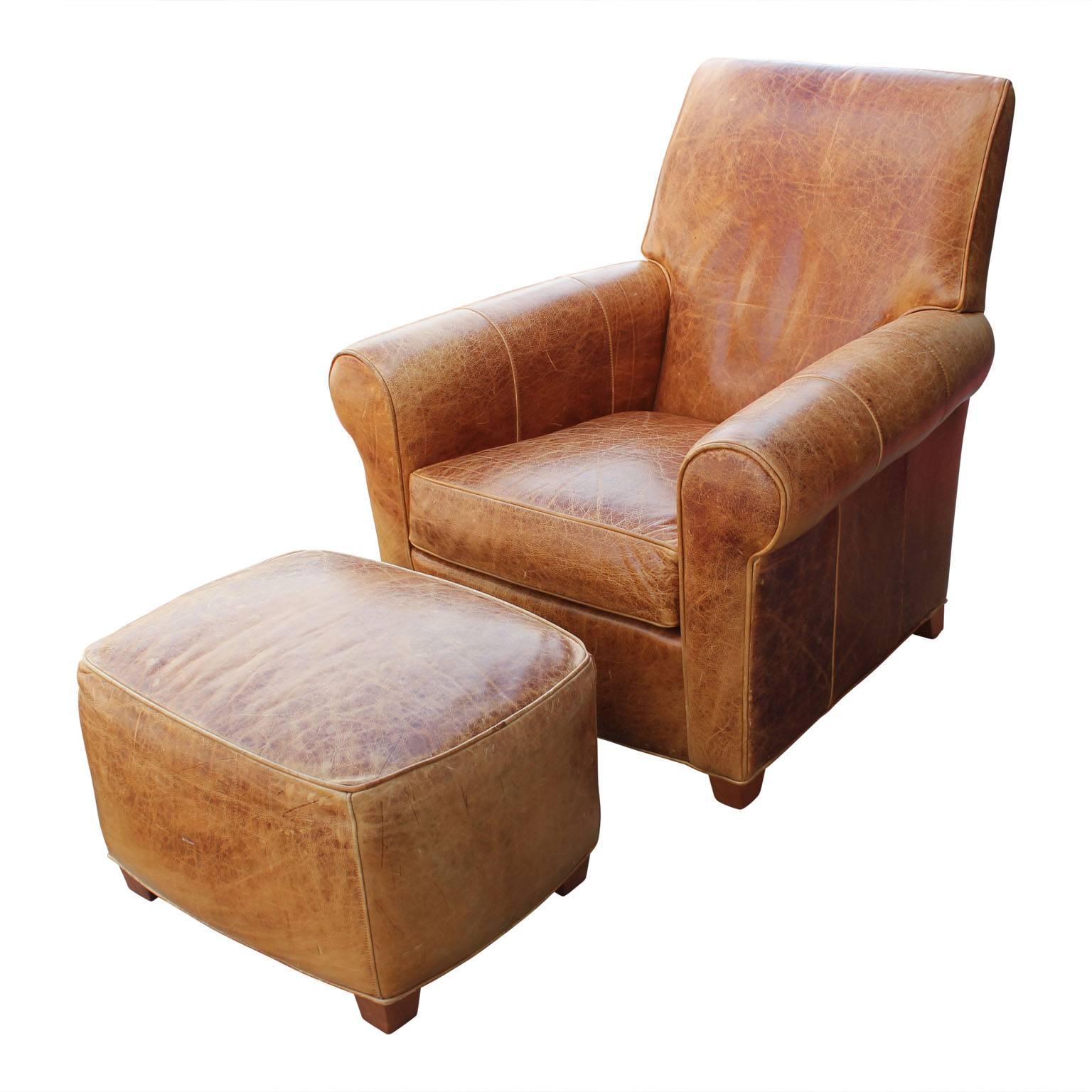 Comfy modern French Art Deco-style brown leather lounge chair and ottoman. 

Ottoman dimensions: 26 in. W x 20 in. D x 16 in. H.