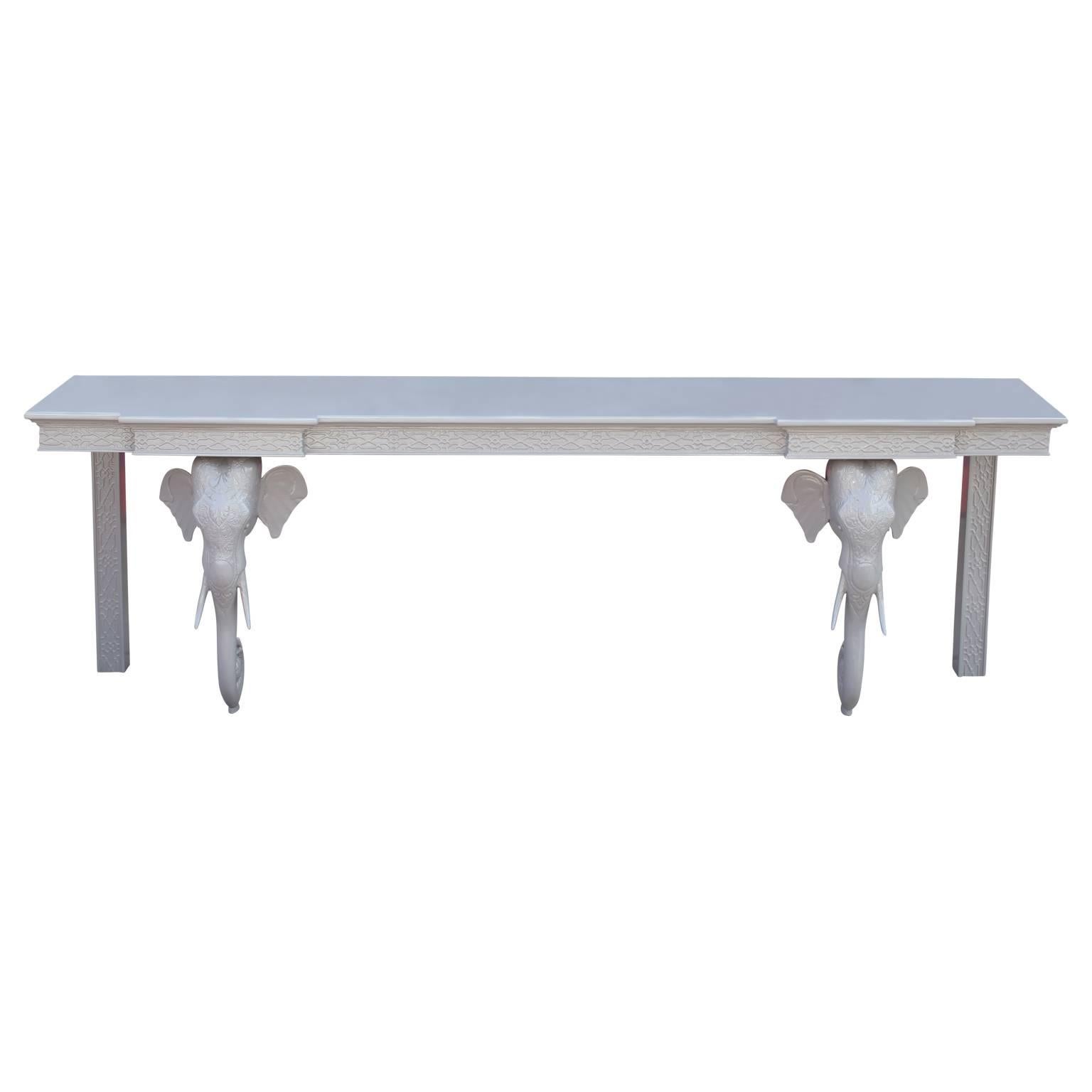 Wonderful elephant console table in the style of Gampel-Stoll with beautiful carved detailing that we had freshly lacquered in a light grey. Unique statement piece for any room!