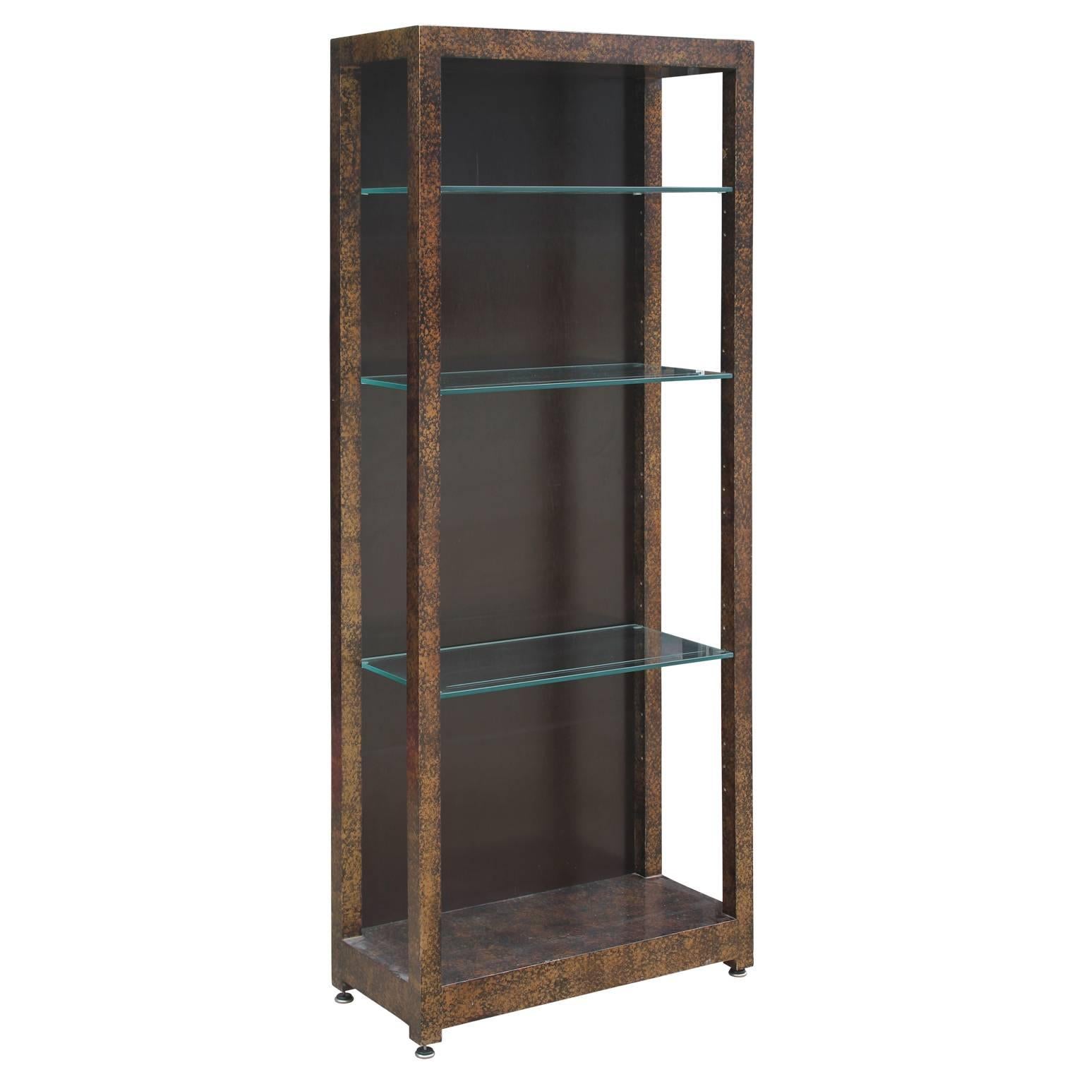 Pair of gorgeous Henredon oil drop display or book cases with a lovely tortoise finish with glass shelves. Each book case can hold up to four adjustable shelves, making them easily customized.