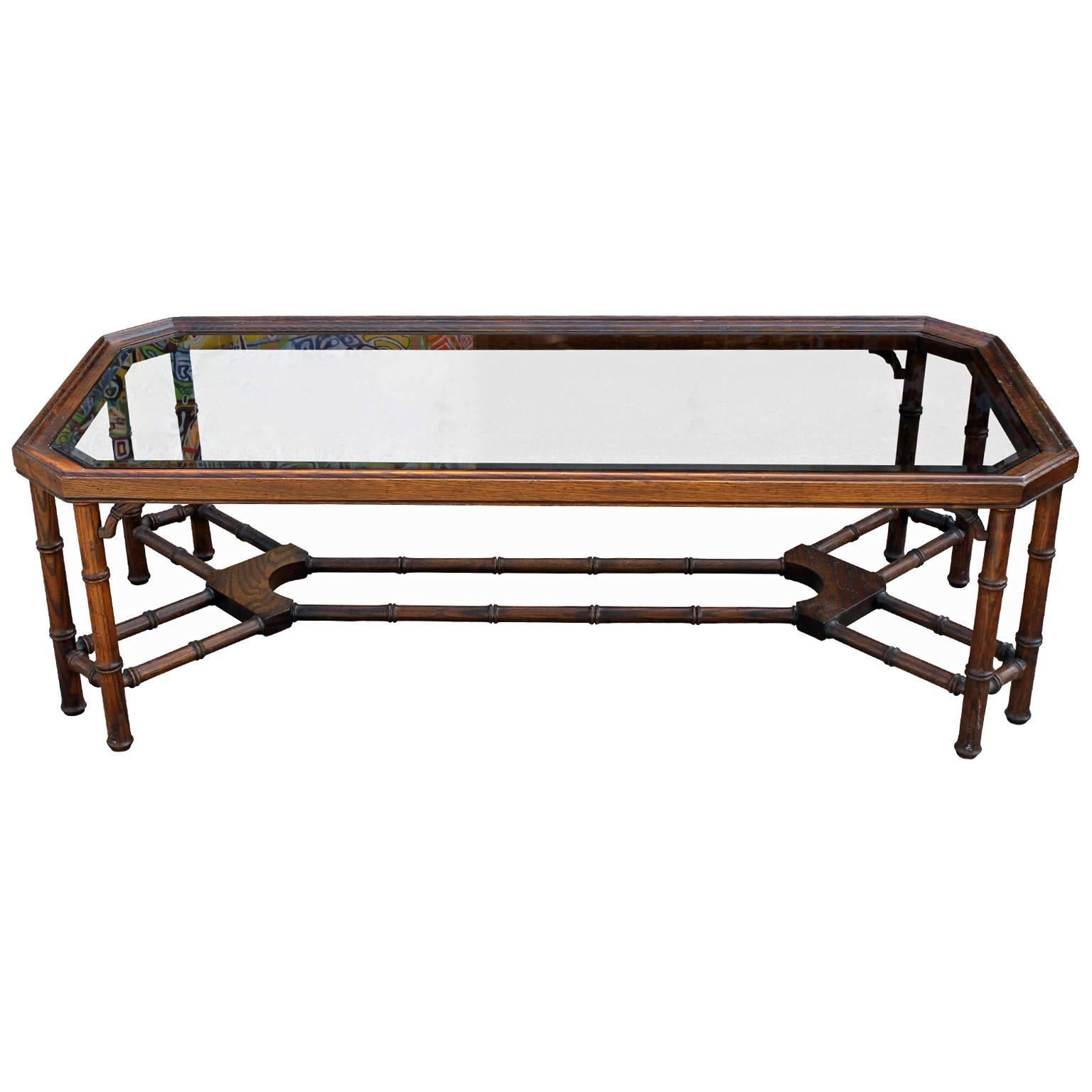 Great faux bamboo and glass walnut coffee table attributed to Baker Furniture. In excellent vintage condition.