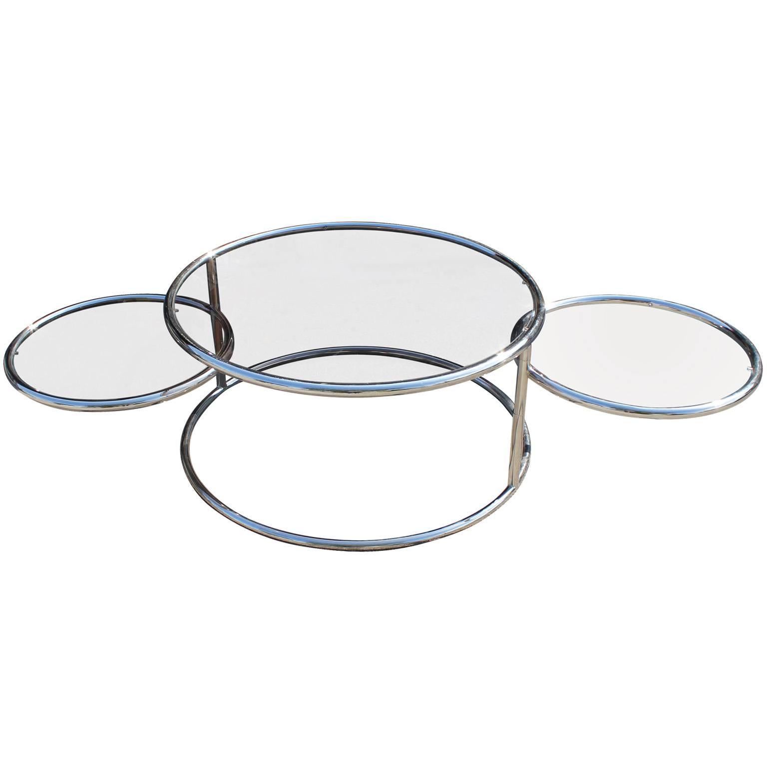 Great adjustable, round coffee table-smaller circular tables swivel 360 degrees. Table extends from 34" wide up to 77" wide. Table is constructed of chrome and lightly smoked glass.