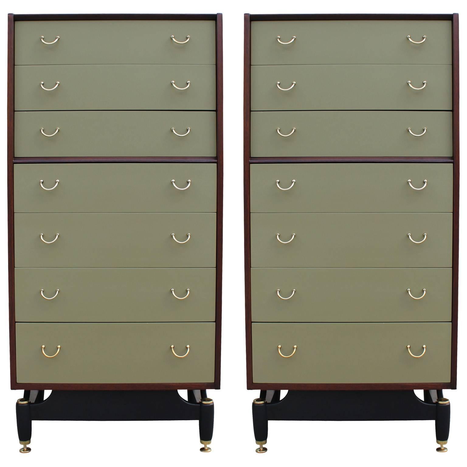 Wonderful pair of matching tall dressers or lingerie chests with shiny brass hardware. Case is finished in a medium dark walnut while drawer fronts are finished in a moss green lacquer. Black lacquered base provides nice negative space. Dressers