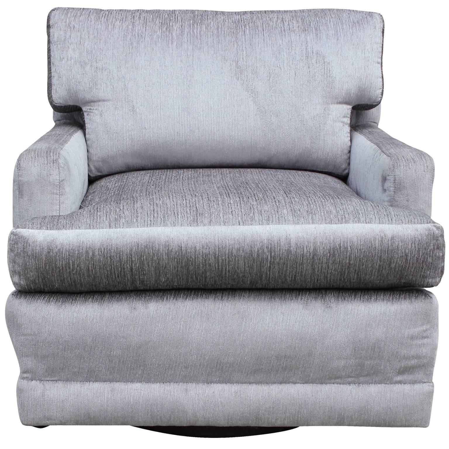 Gorgeous swivel lounge chair freshly upholstered in a luxe silver velvet. Chair pairs clean lines with dramatic upholstery creating a one of a kind piece.