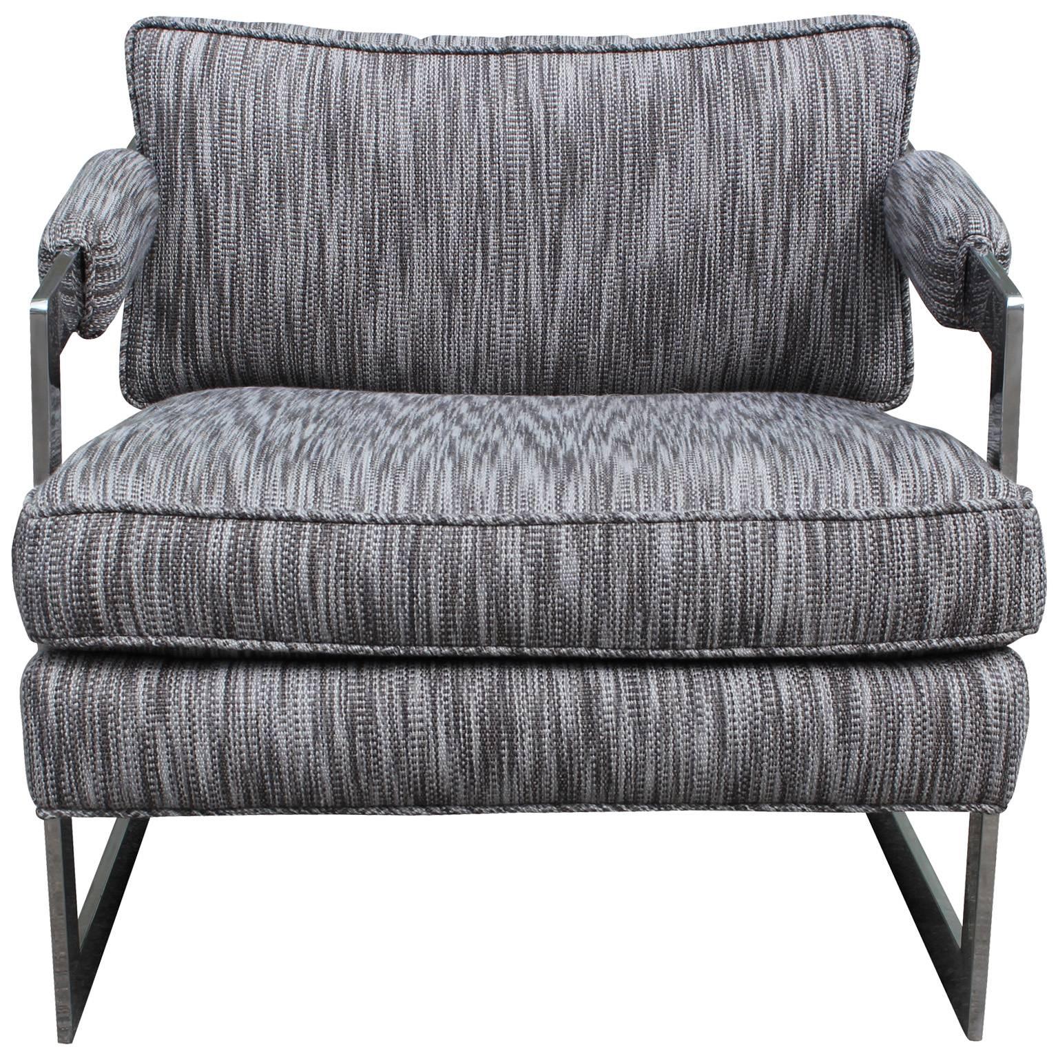 Wonderful lounge chair in the style of Milo Baughman. Heavy chrome flat bar cantilevered frame is in great shape. Chair is freshly upholstered in a grey woven ikat. Beautifully constructed and very comfortable.