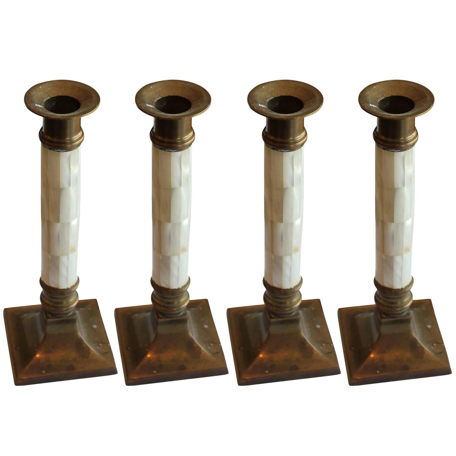 Lovely set of four vintage candlesticks. Constructed of brass and mother of pearl. Brass has a nice patina.