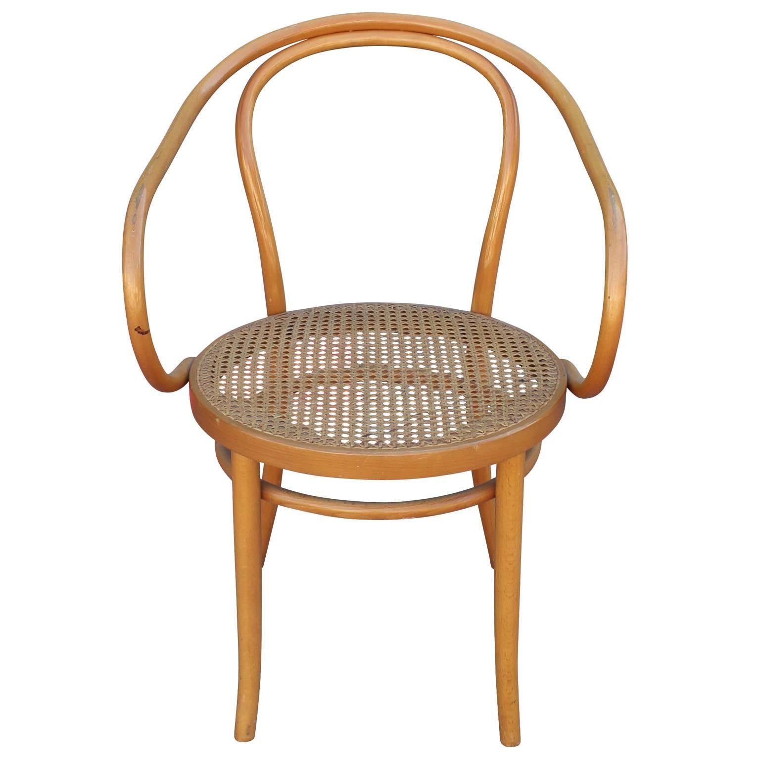 Beautiful set of 6 sculptural Thonet 209 dining chairs. Designed by Auguste Thonet for Thonet, manufactured In Germany. Bentwood and rattan. Round seats are covered in cane which is in excellent condition. Bentwood frames have a wonderful organic