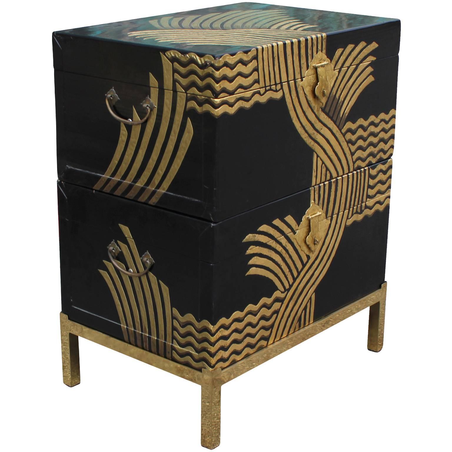 Fabulous stacked chests with black lacquer and gold on a brass base. Abstract motif chinoiserie. The chests have Asian writing the backs. 