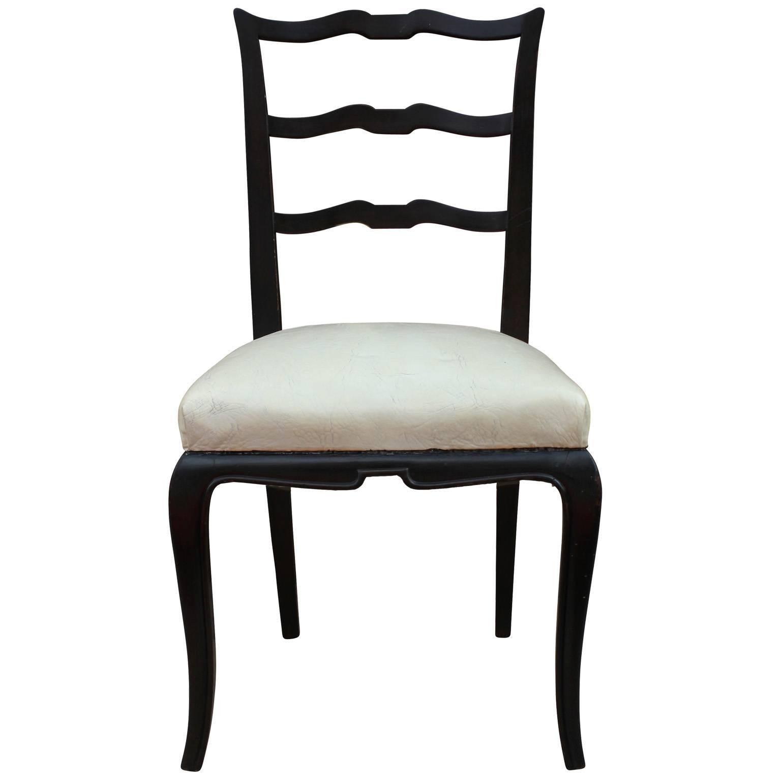Fabulous set of 8 Argentinian dining chairs. The modern style ladder back chairs are finished in an deep dark brown almost ebony stain. Chairs are upholstered in original cream naugahyde (They need updating). Perfect in a transitional space.