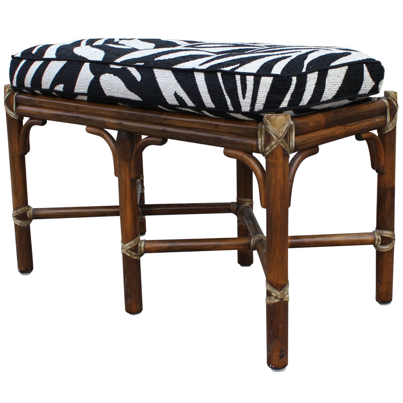 Great, small scale bamboo bench. Bamboo base is in excellent condition. Cushion is upholstered in a zebra print fabric which could use updating. 