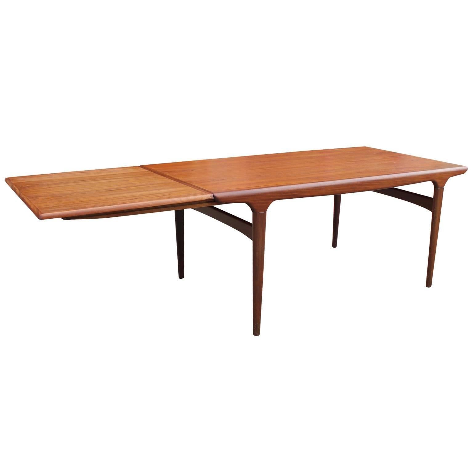 Beautiful Danish modern dining table in teak. Table has soft, clean lines. One extendable leaf. Table is 96