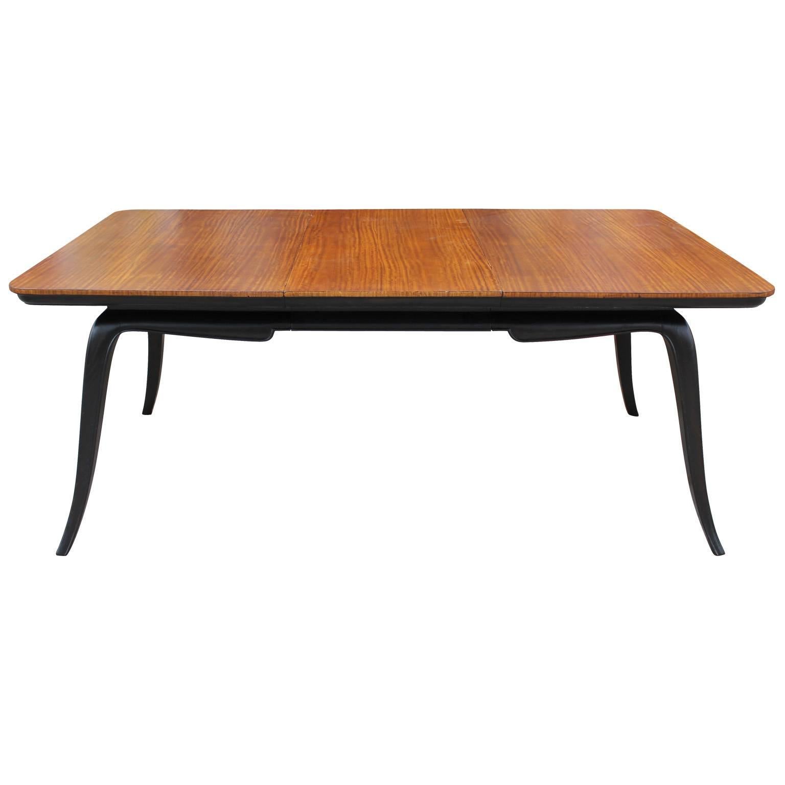 Beautiful dining table made in Argentina, circa 1940-1950. The table's top features a nicely grained fruitwood and a base with a deep ebony stain. The legs are sculptural and splayed elegantly. The table is stunning from all angles. In the style of