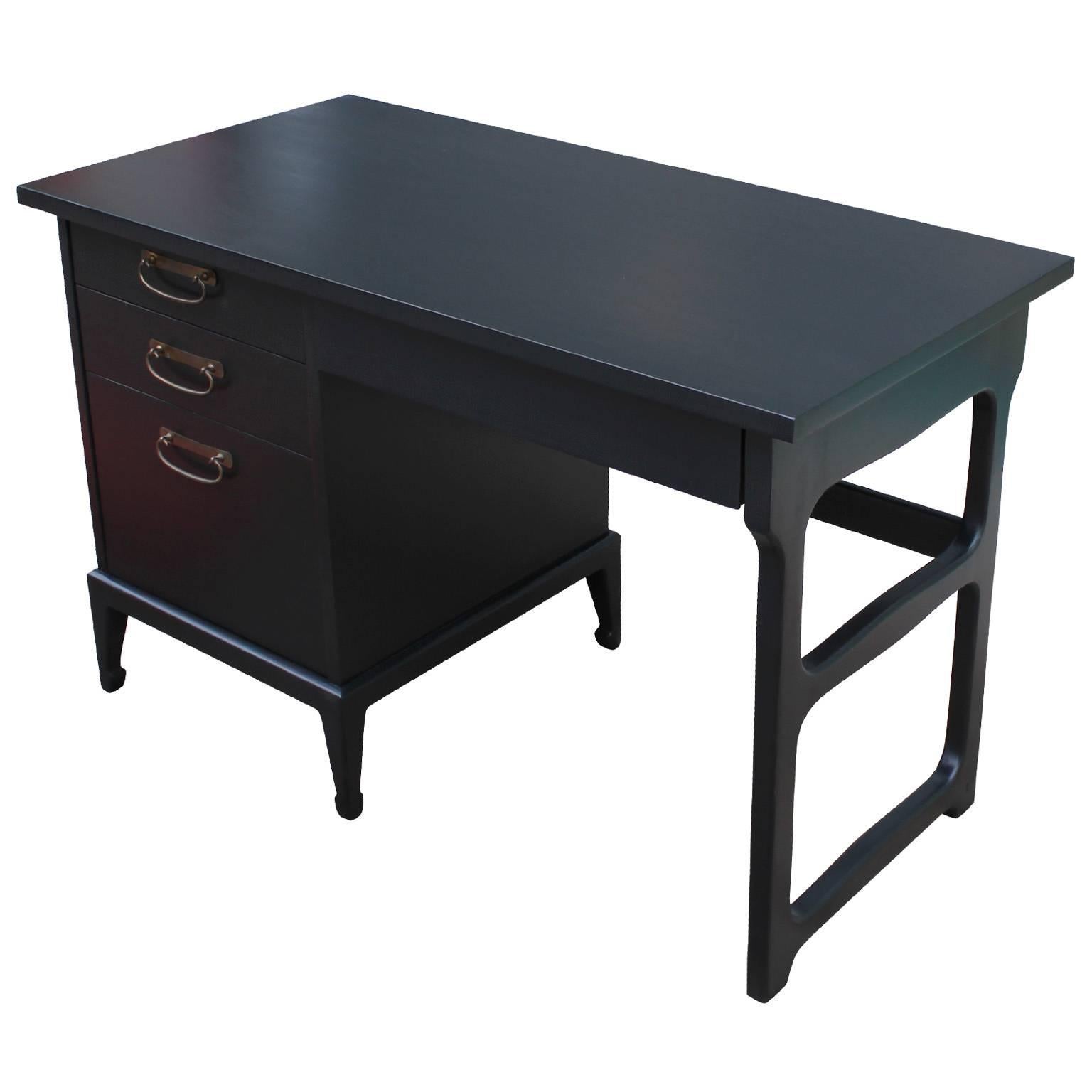 Elegant desk by American of Martinsville. Freshly finished in a deep ebony stain. Patinaed Brass hardware. Three drawers provide excellent storage.
