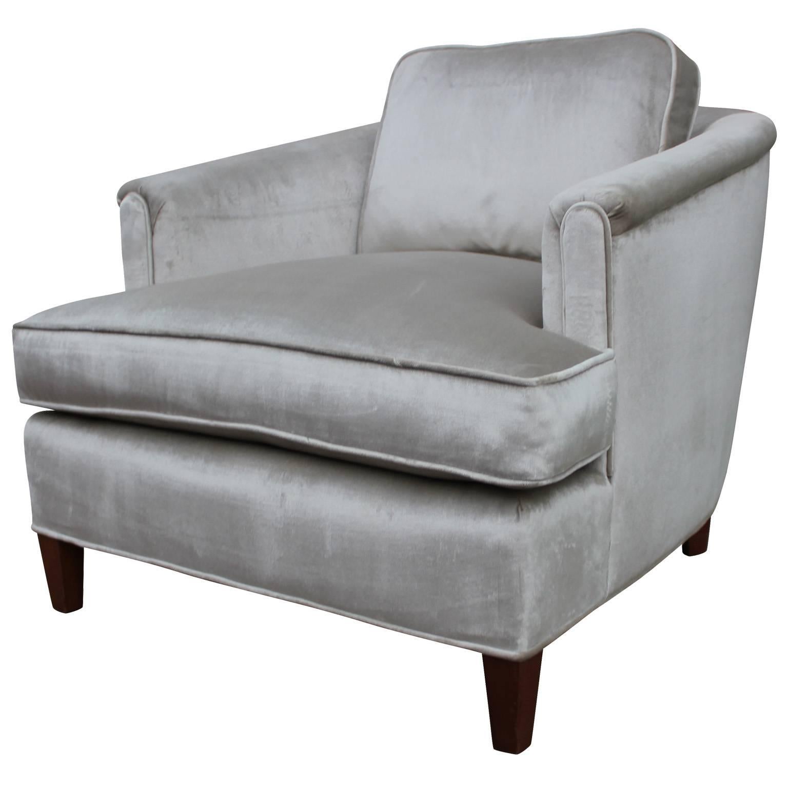 Pair of comfortable and elegant barrel back lounge chairs. Chairs are freshly upholstered in a luxe silver velvet. Gently tapered legs are finished in a dark walnut. Stunning from all angles.