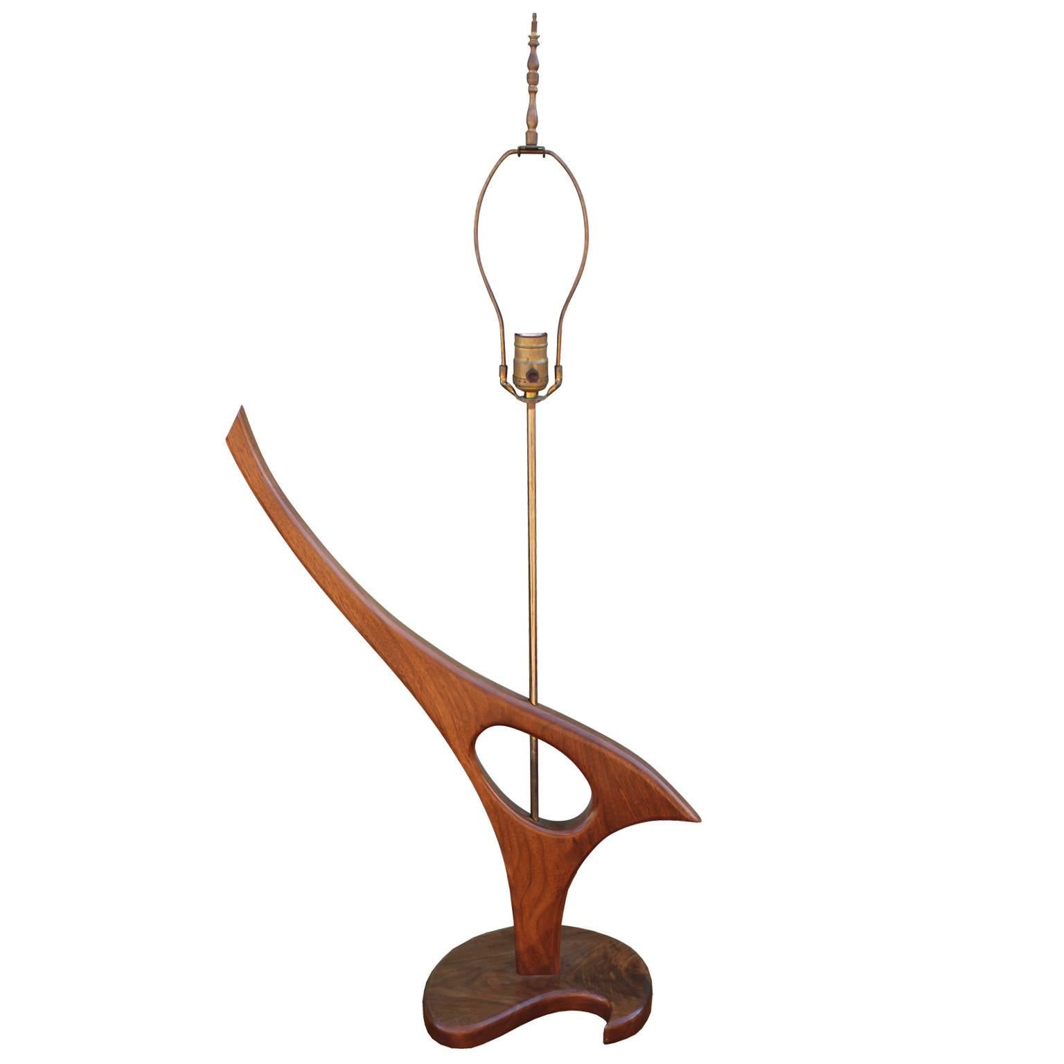 Sculptural pair of walnut table lamps. Organic, bird shaped lamps on paisley shaped bases. Brass hardware.