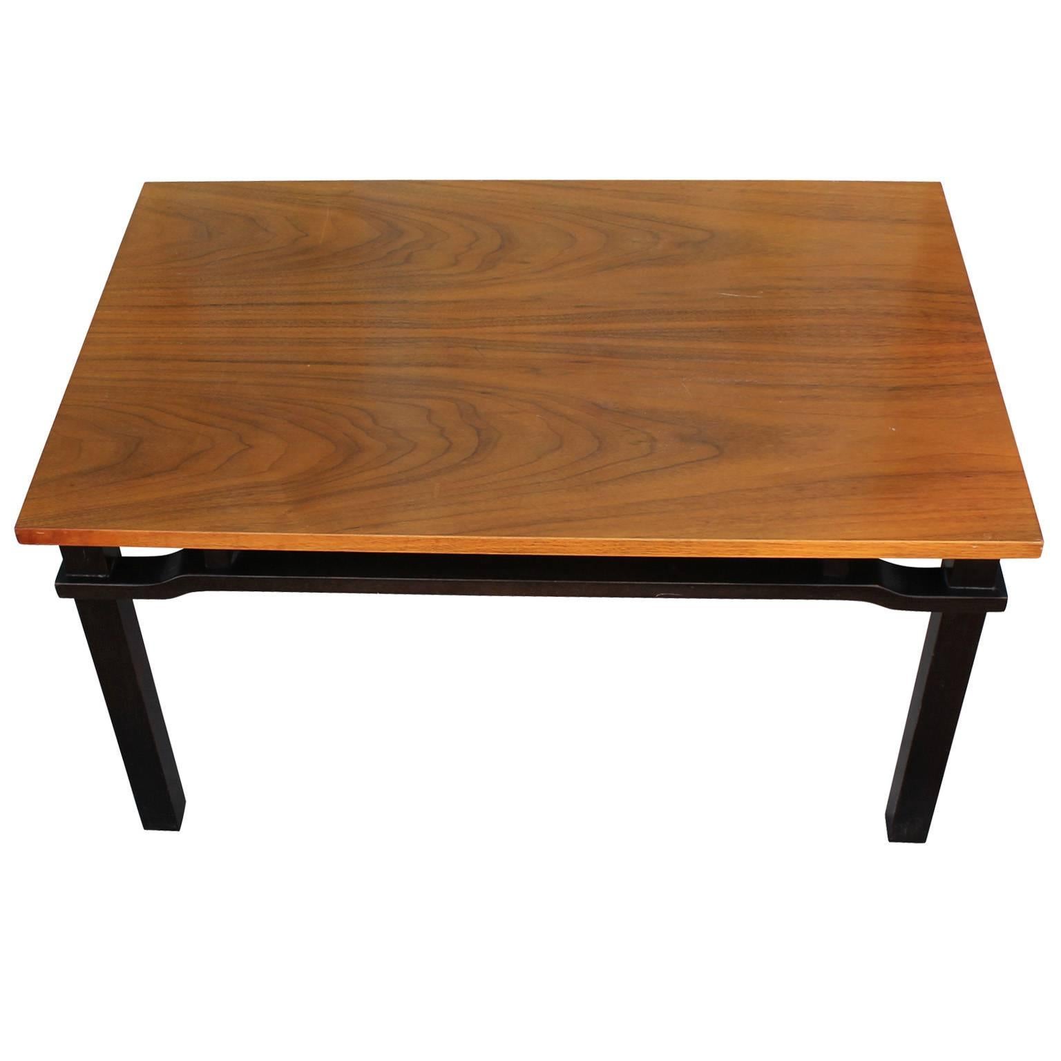 Wonderful cocktail or coffee table in the style of Dunbar,  Baker Furniture, or Michael Taylor. Base is stained in a deep ebony. Lively grain. Matching side tables available. 