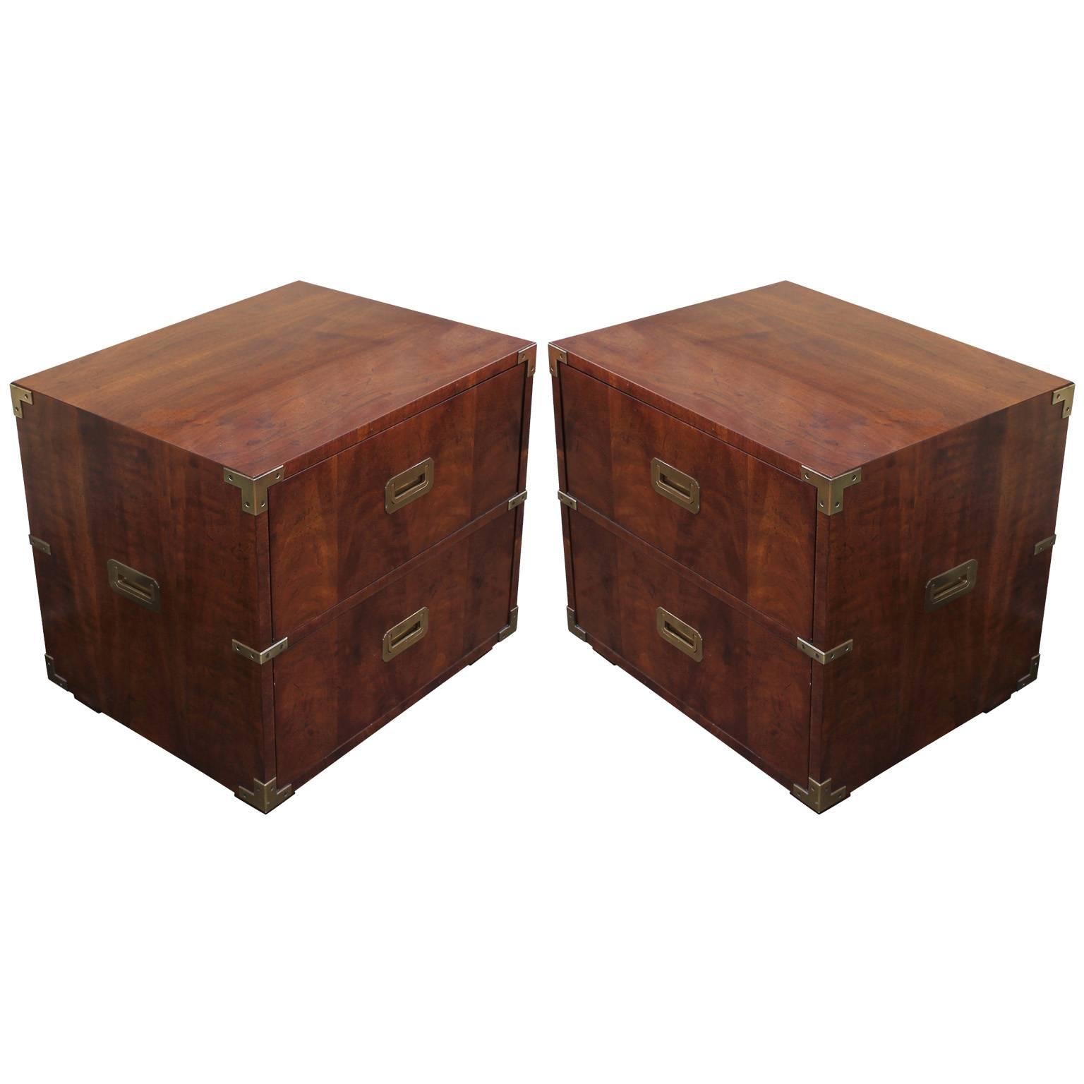 Wonderful pair of campaign style night stands or side tables by Henredon in walnut. Tables have wonderful inset brass hardware and accents. Tables rest on low square legs. In excellent vintage condition.