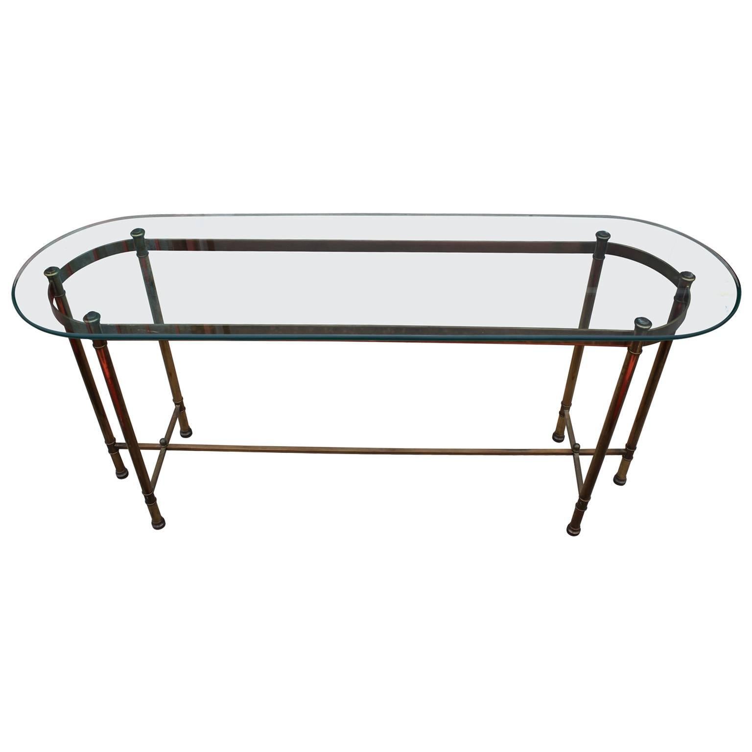 Wonderful brass and glass console by Labarge. Table base has simple, clean lines with the perfect amount of detailing. It has a thick glass top with a bevel.