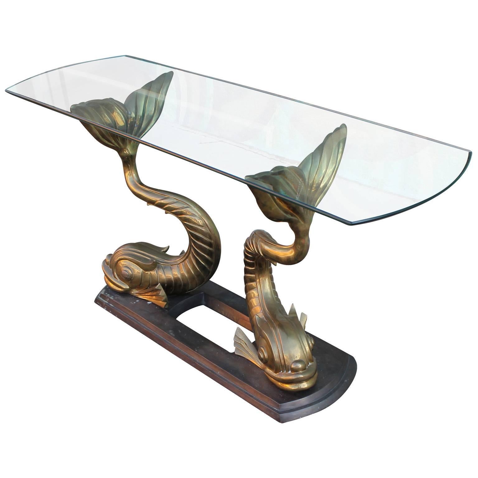 Incredible console table. Brass or bronze table base depicts two sculptural Koi fish. Topped with a thick glass, rounded top.  Stunning in any room. Table has an excellent patina. 