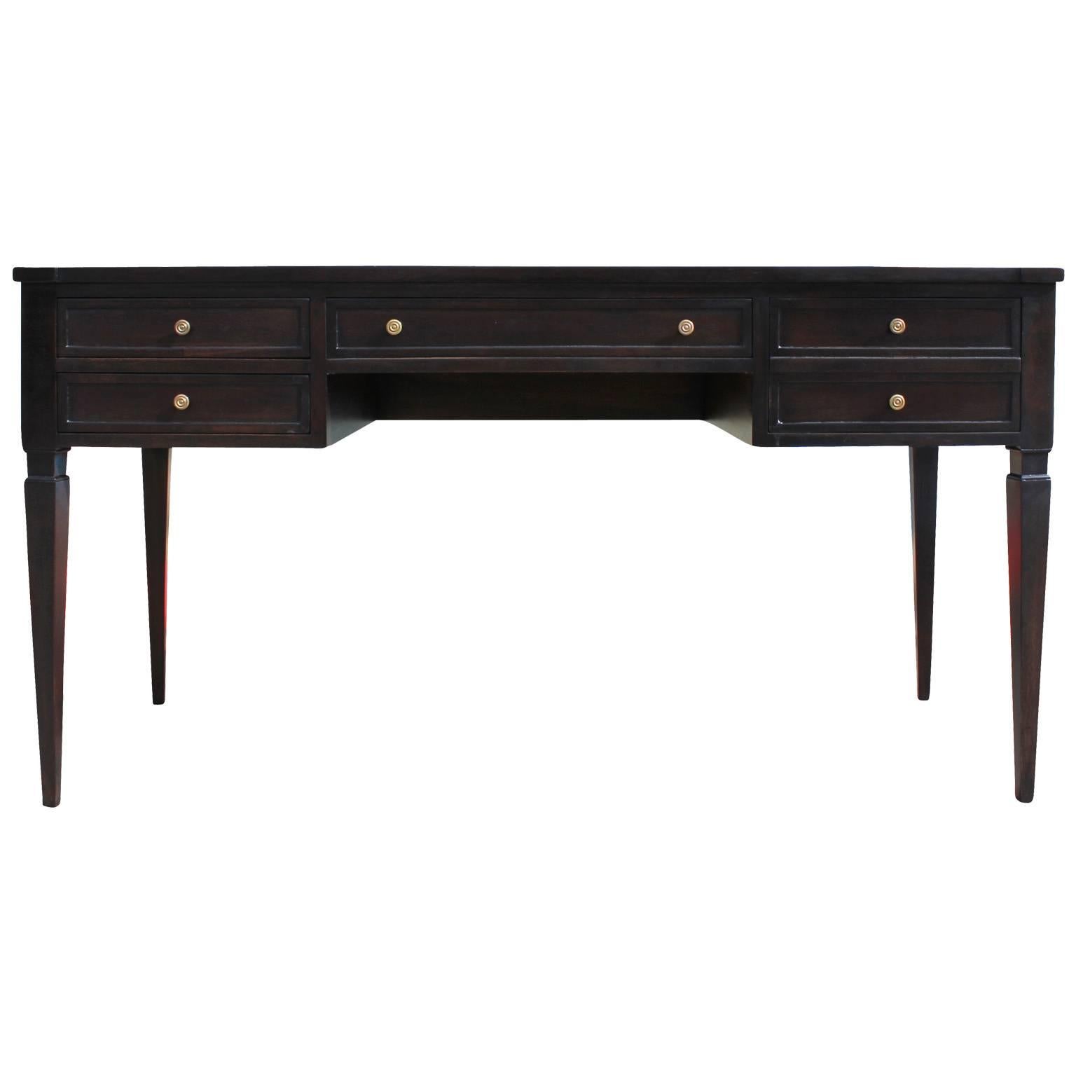 Elegant executive desk by Mount Airy. Desk has wonderful lines with a slightly bowed shape and an excellent attention to detail. Freshly finished in a deep ebony stain. Four drawers are accented with brass pulls.
