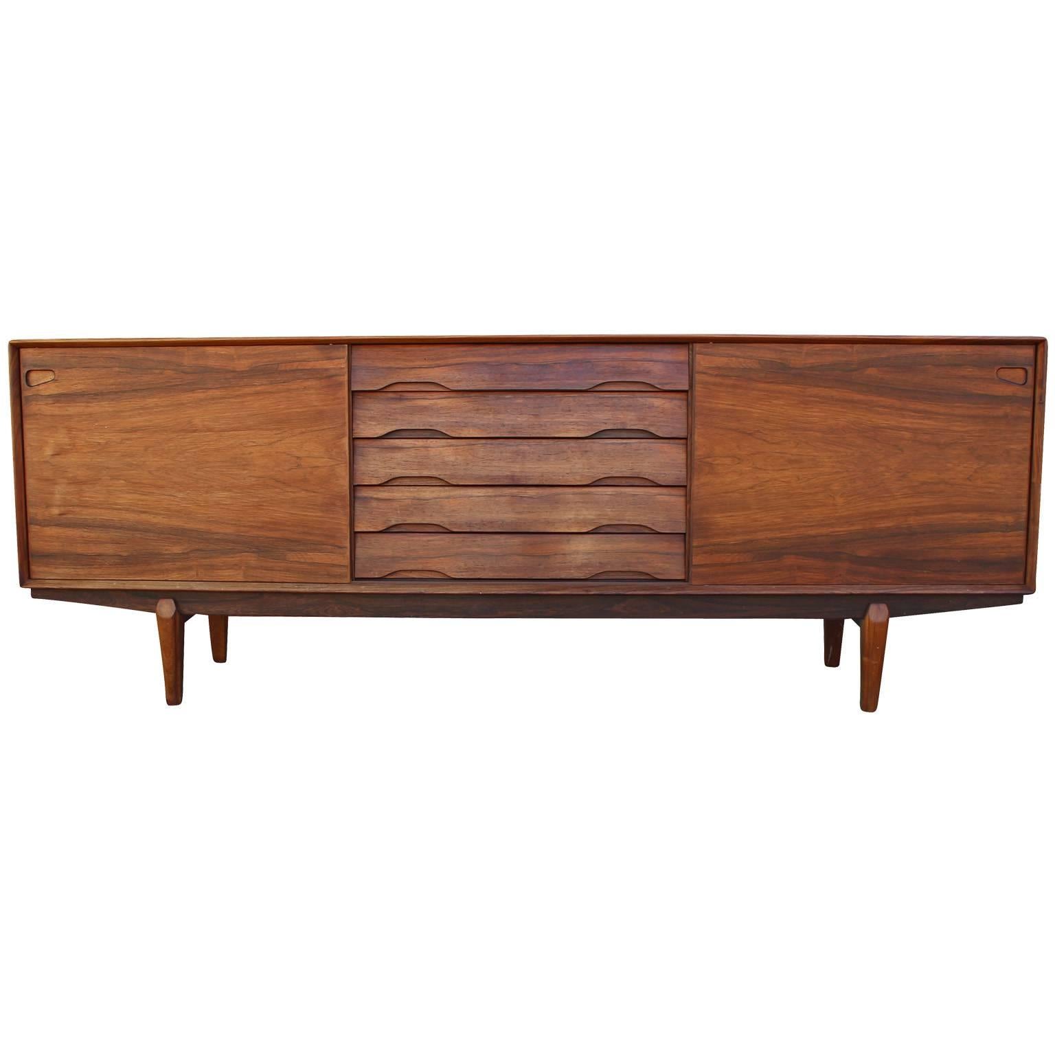 Wonderful credenza and hutch by Skovby. Rosewood has a dramatic grain. Hutch lifts off credenza. Credenza has two sliding doors and five drawers. Sliding doors open up to adjustable shelving. Top of five drawers is lined in green felt and slotted