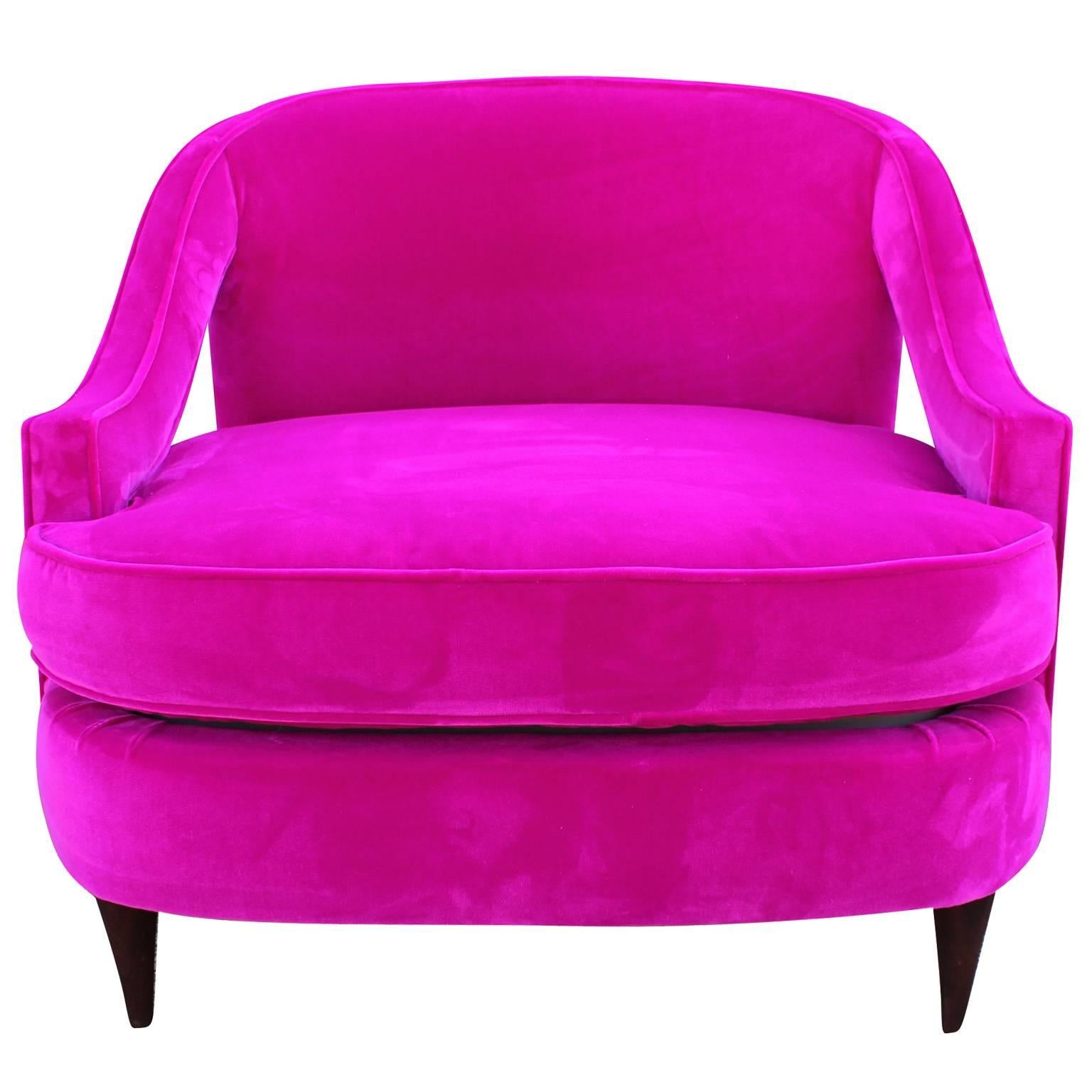 Ultra glam chair freshly upholstered in a luxe fuchsia or hot pink velvet. Chair has elegant lines with swooped upholstered arms and finished with dark walnut tapered legs. Perfect accent chair!