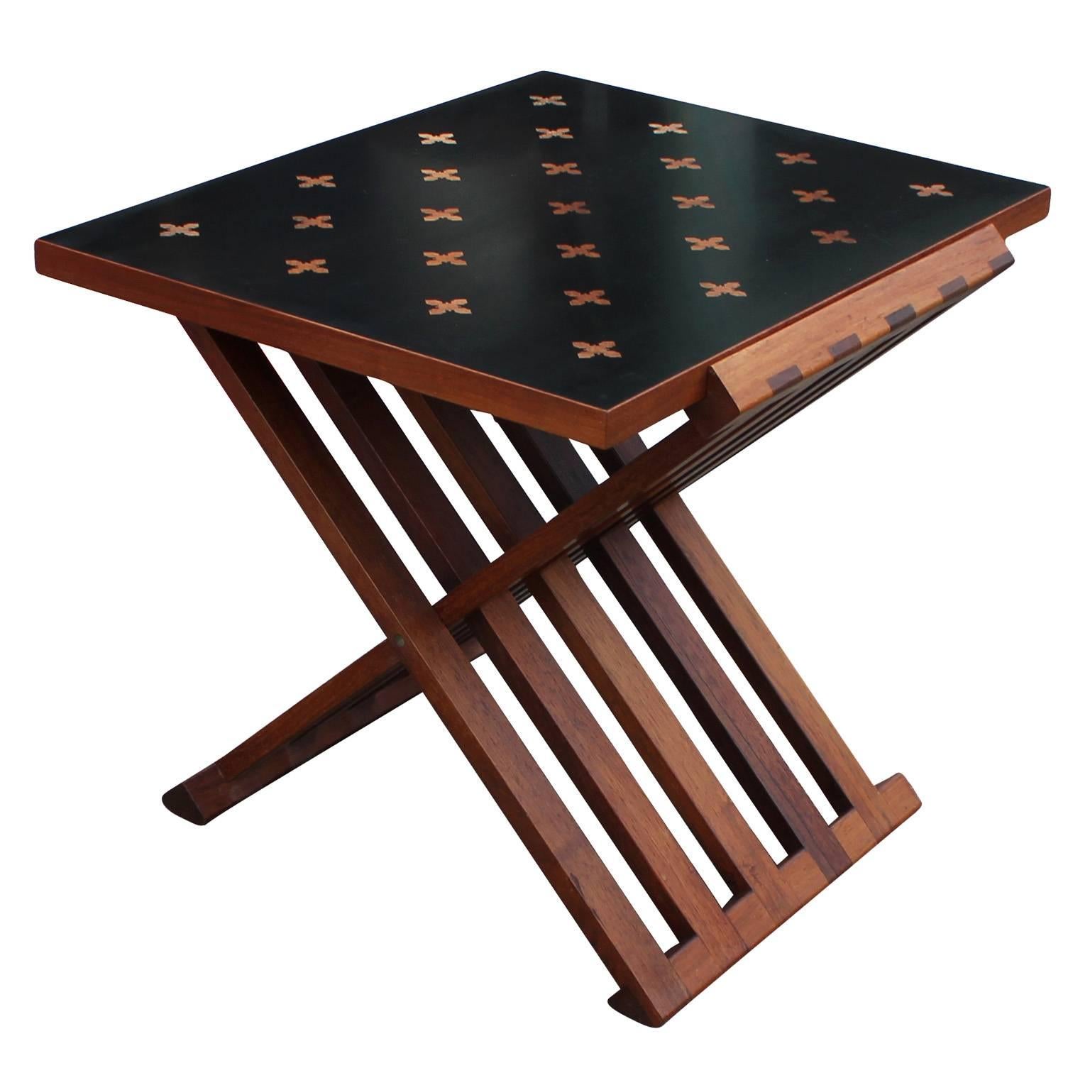 Parquetry occasional table, model 5425, designed by Edward Wormley for Dunbar. Folding rosewood base holds the mahogany-edged top with bleached mahogany parquetry. Inquire for matching cube side table.