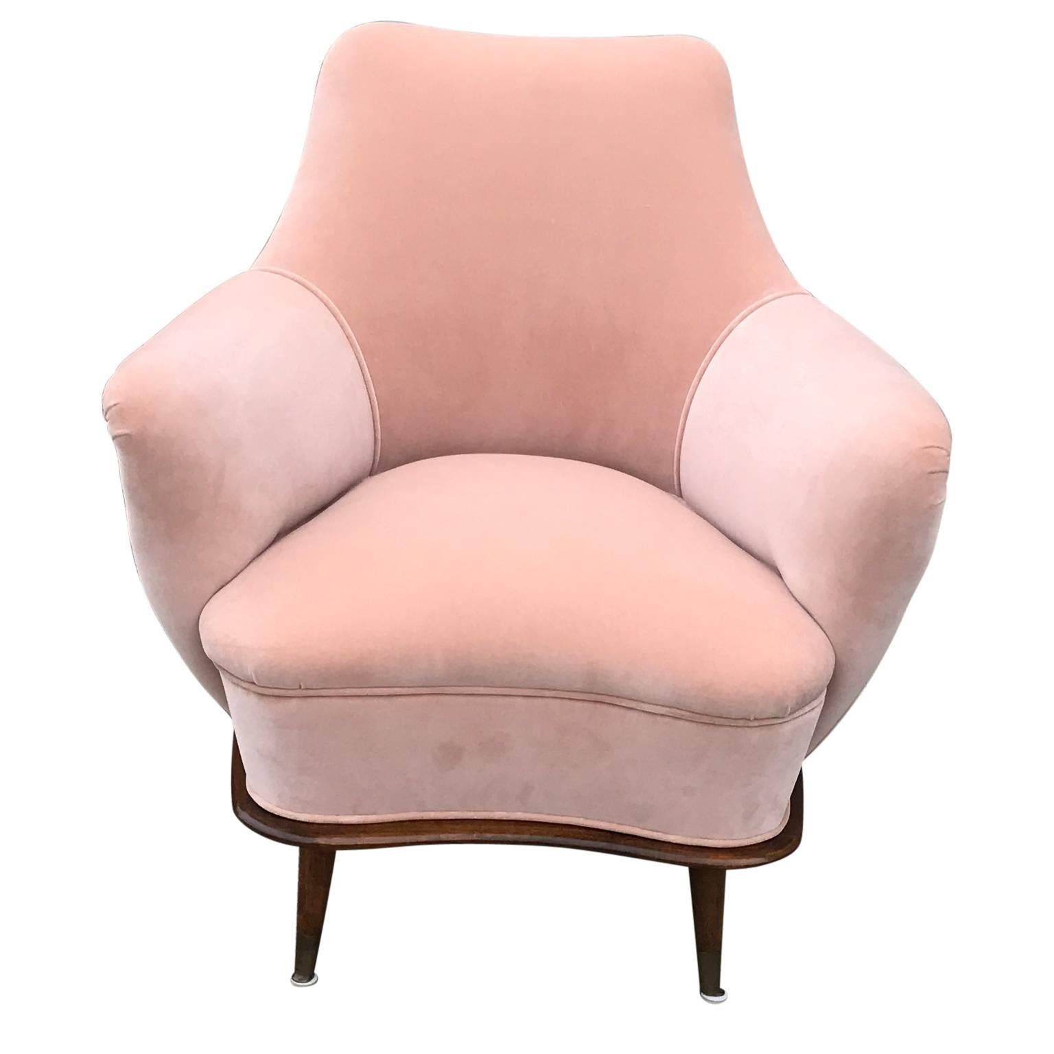 Lovely Modern Pair of Blush / Pink Velvet Italian Lounge Chairs with Walnut Bases. The chairs have been fully stripped to the frame and restored. The chairs Date from the late 1940s or the early 1950s. Subtle curved brass caps accent the base of the