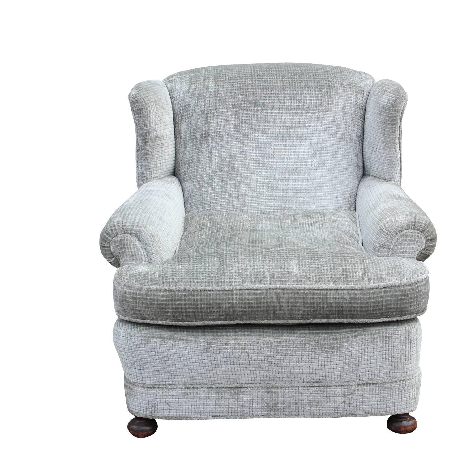 Ultra comfortable rolled arm wingback lounge chair with a slight recline restored in a square pattern soft grey velvet with bun feet.