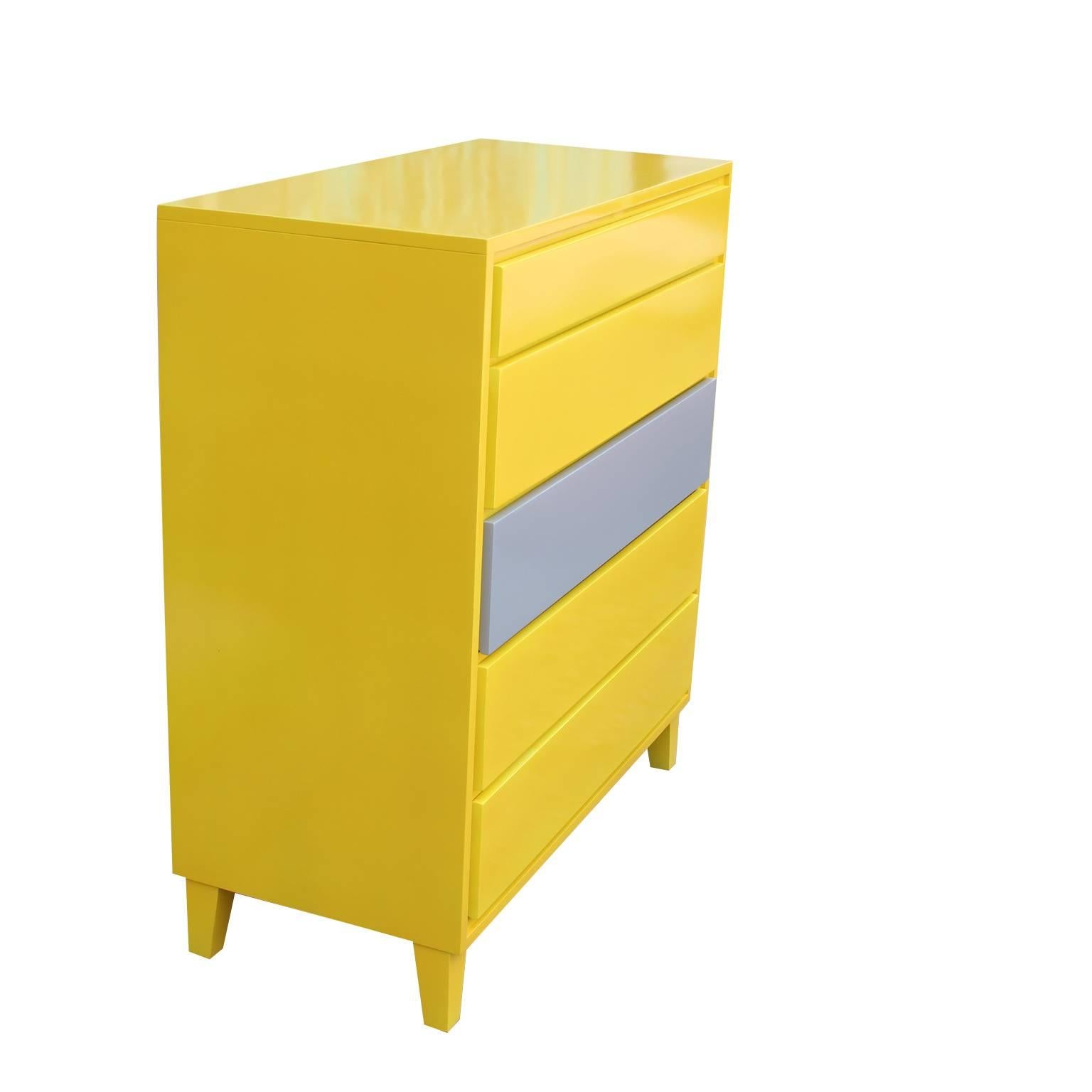 Modern Conant ball Furniture Company six-drawer dresser recently lacquered in yellow and with a grey accent drawer. The second drawer is divided into three sections for easy organization, while the other drawers are normal.