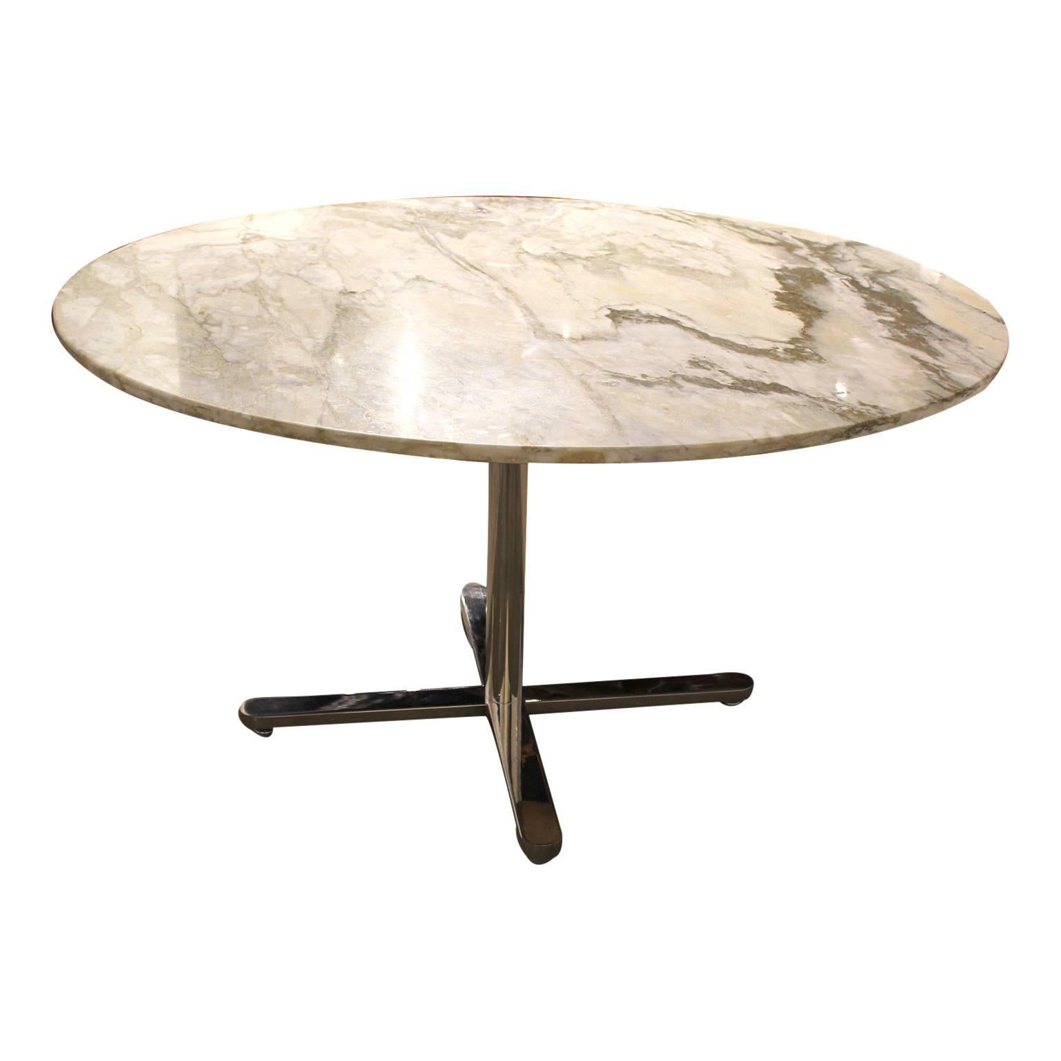 Gorgeous round white marble dining table with a chrome base in the style of Nikos Zografos. Can comfortably seat five dining chairs.