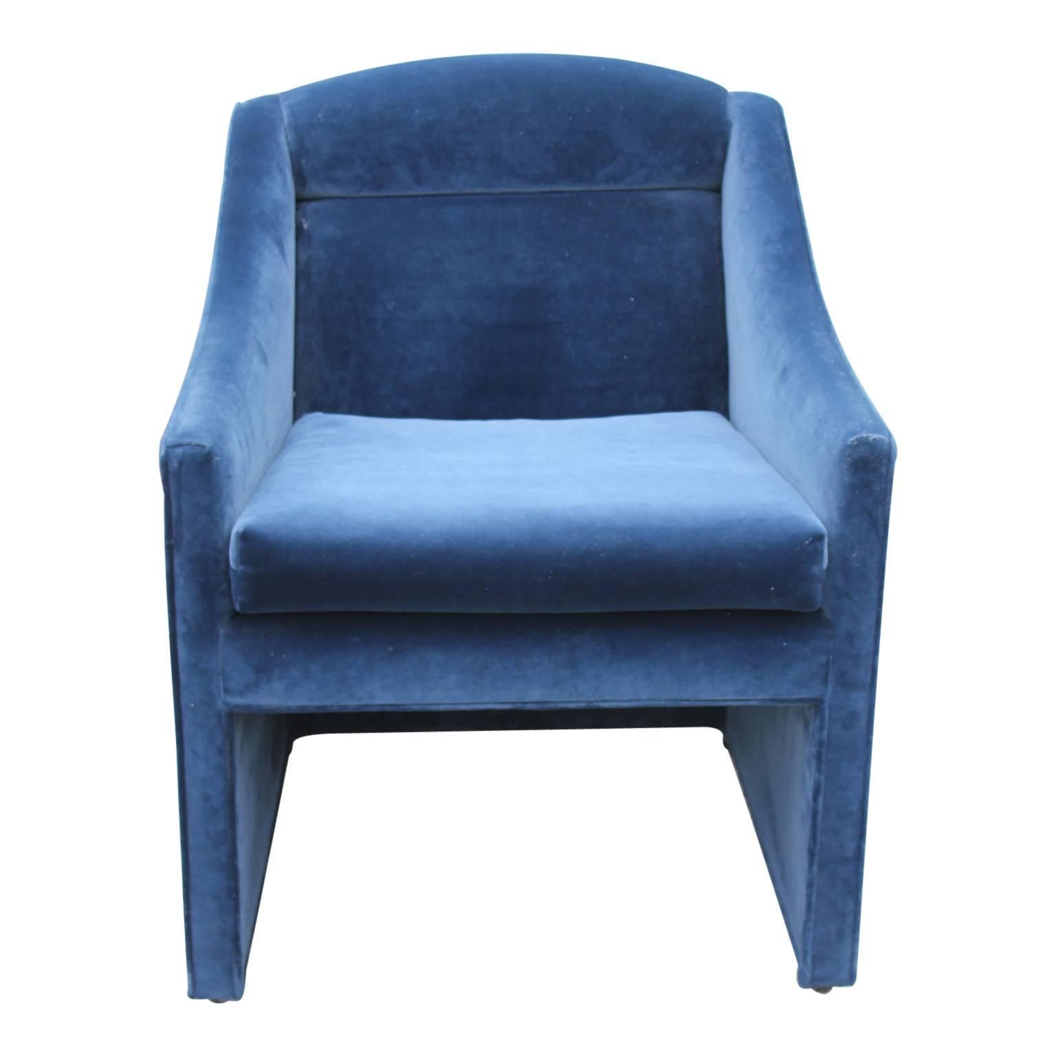 Pair of sophisticated lounge or armchairs in a deep blue velvet color.