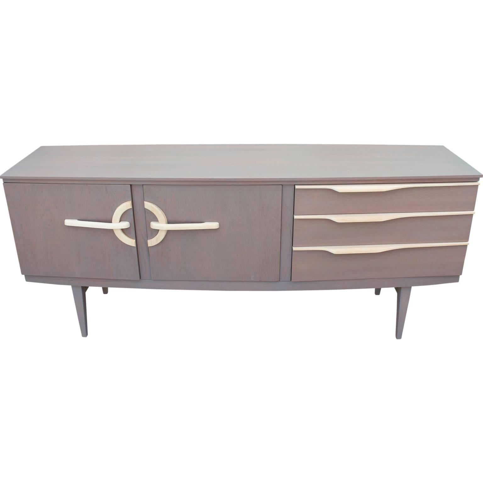 Gorgeous credenza or sideboard recently refinished in a light gray that allows some of the natural wood grain to show through, with bleached wood accents. Super unique! Top drawer reveals 3 divisions to help store small items.