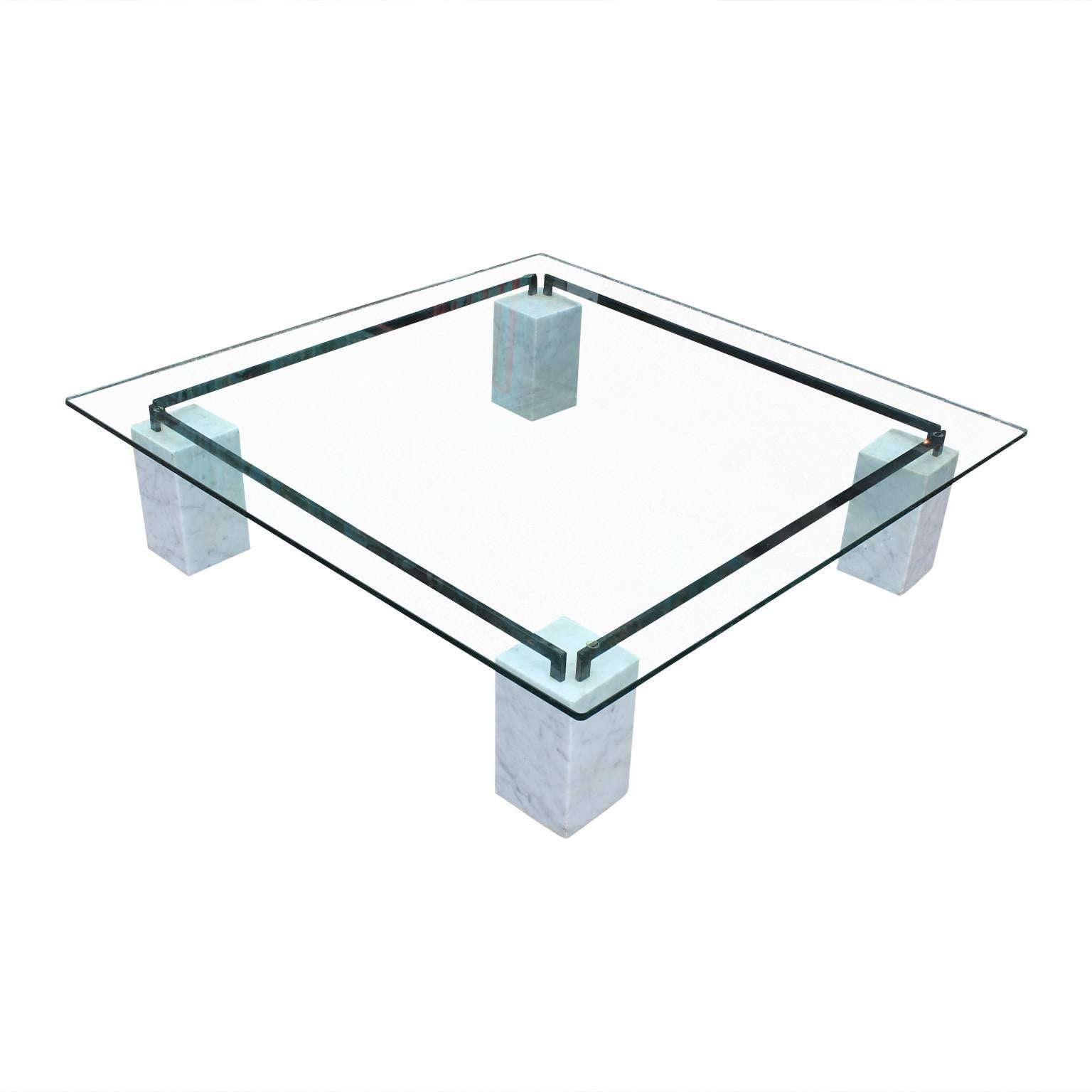 Gorgeous modern square glass Cattelan coffee table with Carrara marble bases and an iron frame. Perfect for the modern home!