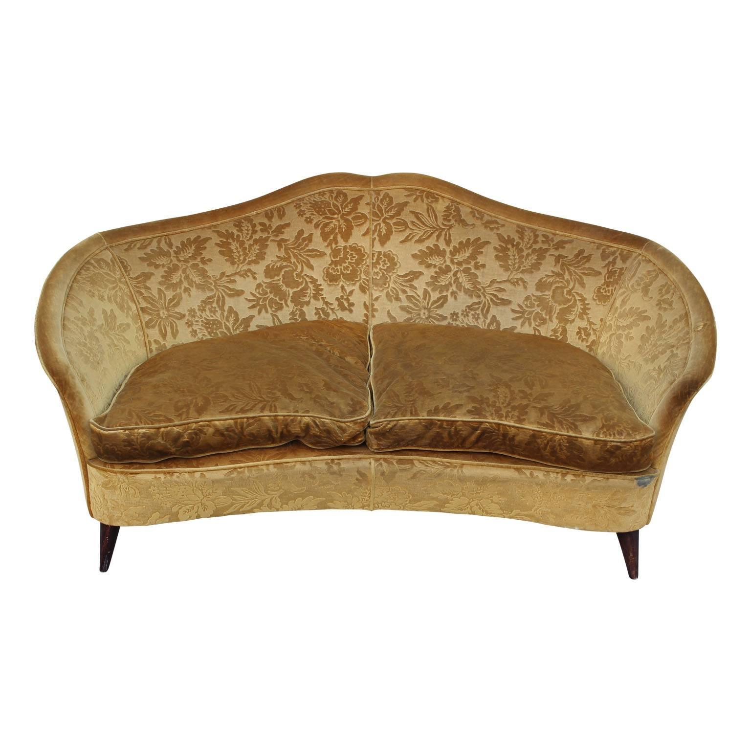 Refined Italian love seat from the 1950s in its original gold floral velvet. Sure to add a touch sophistication to any home or lobby. Matching lounge chairs available as well.