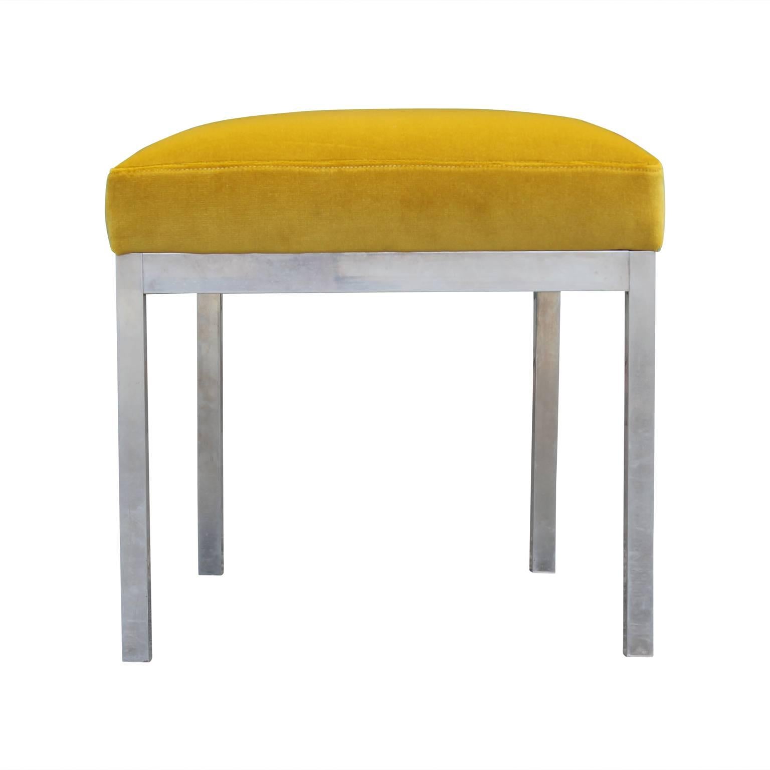 Pair of unique polished aluminum trapezoid footstools ottomans attributed to Milo Baughman or Design Institute of America. Recently reupholstered in gorgeous yellow velvet.