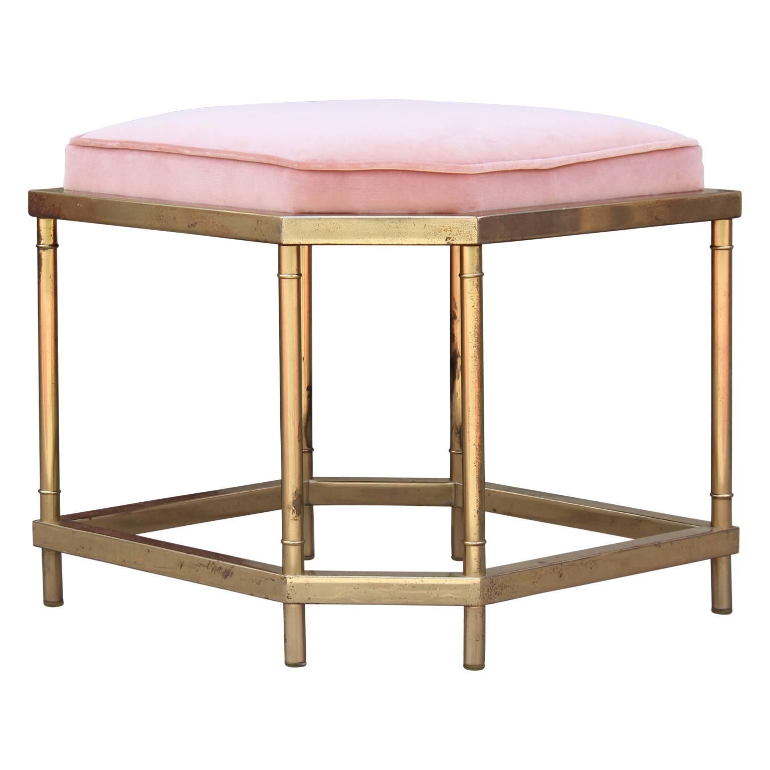 Pair of lux brass foot stools recently reupholstered in a lush pink Kravet velvet. The brass has a nice natural patina to it, consistent with age and use.