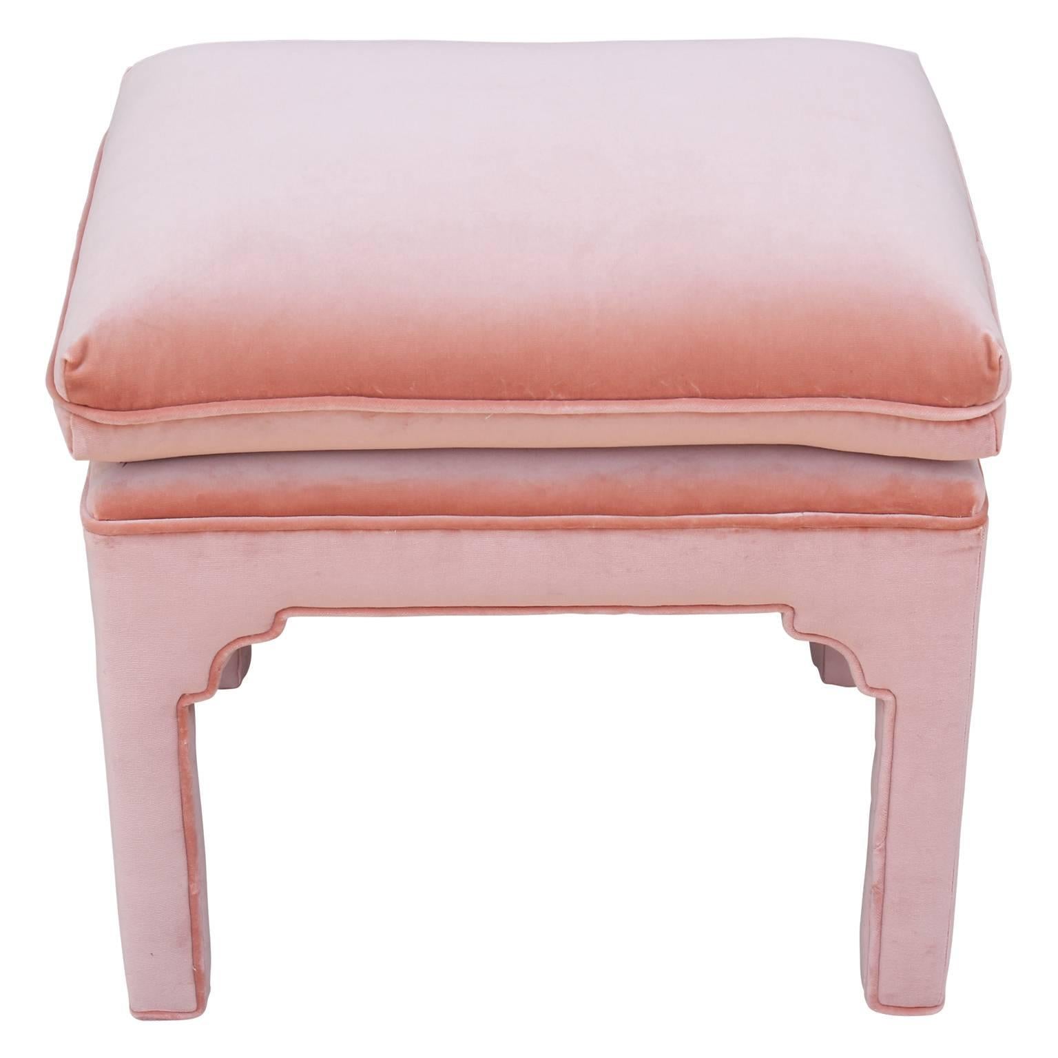 Gorgeous pair of bold Hollywood Regency footstools fully upholstered in lush light pink Kravet velvet. Attributed to Grosfeld House and Baker, these are a great addition to any room.