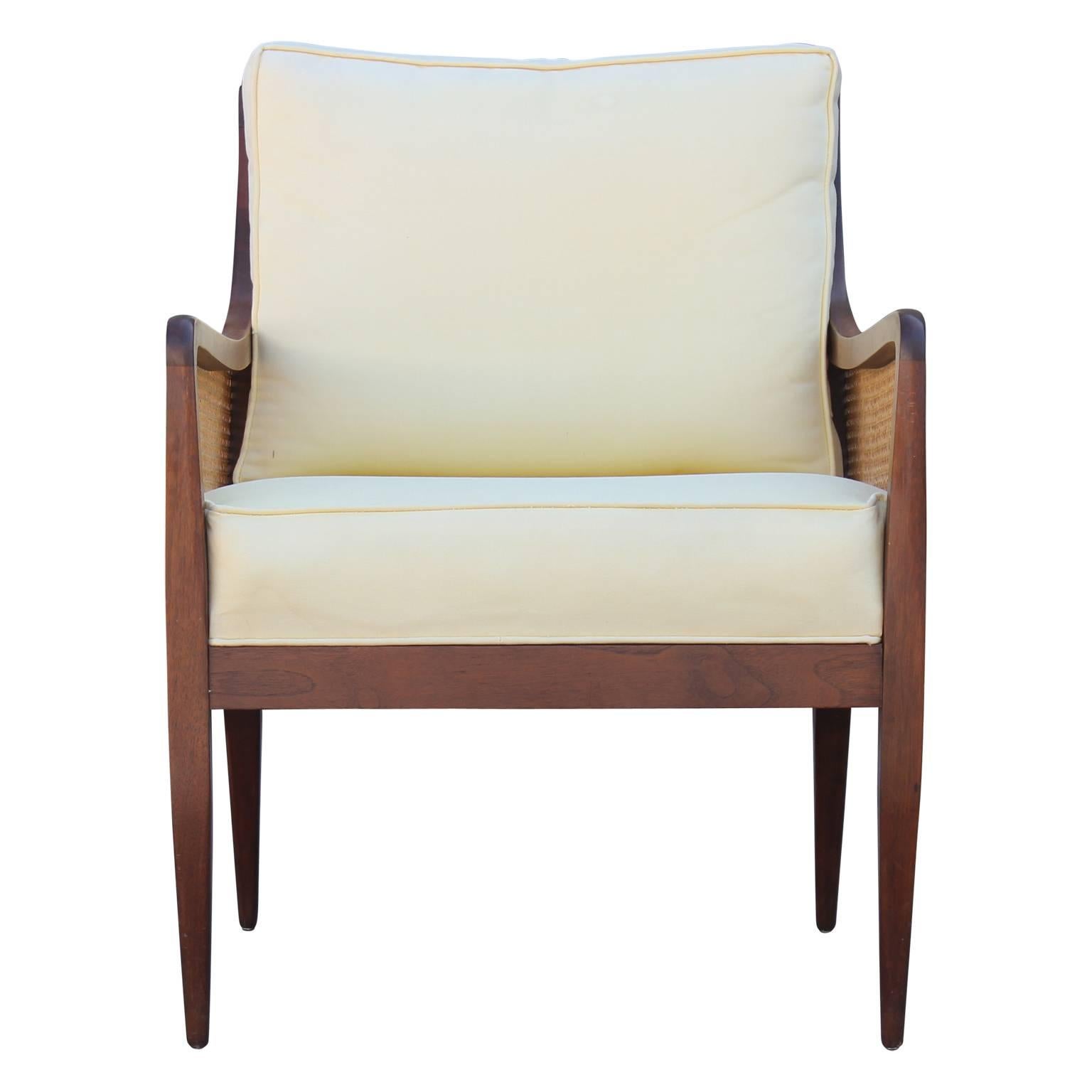 Gorgeous pair of Kipp Stewart cane back walnut lounge chairs as part of Directional's Country Villa collection. The cane is in excellent condition. Cushions are in the original fabric and would need to be redone.