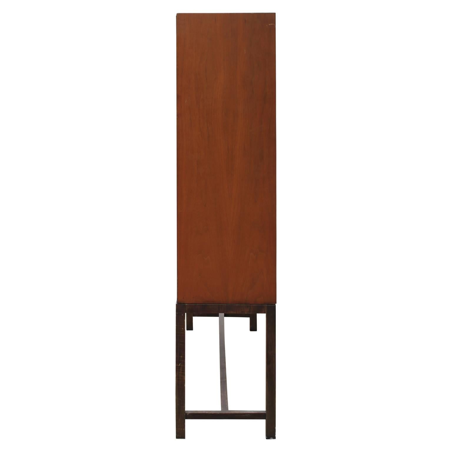 Unique and impressive modern tall cabinet in walnut with cane paneling by Directional / Calvin Furniture Co. The right and left side opens to reveal three shelves and two drawers as pictured. Quality is unsurpassed.