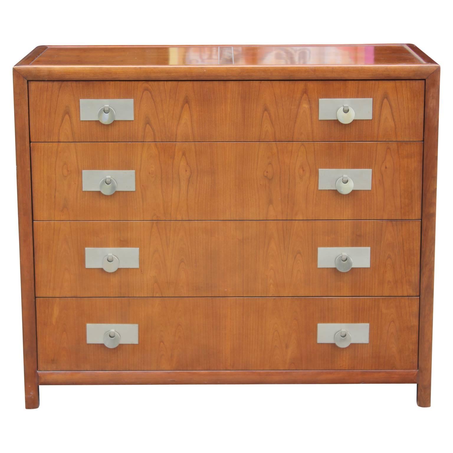 Gorgeous walnut Michael Taylor four-drawer chest of drawers or dresser with nickel-plated pulls by Beaker furniture. Perfect for any modern or mid-mod home. In great condition for its age.