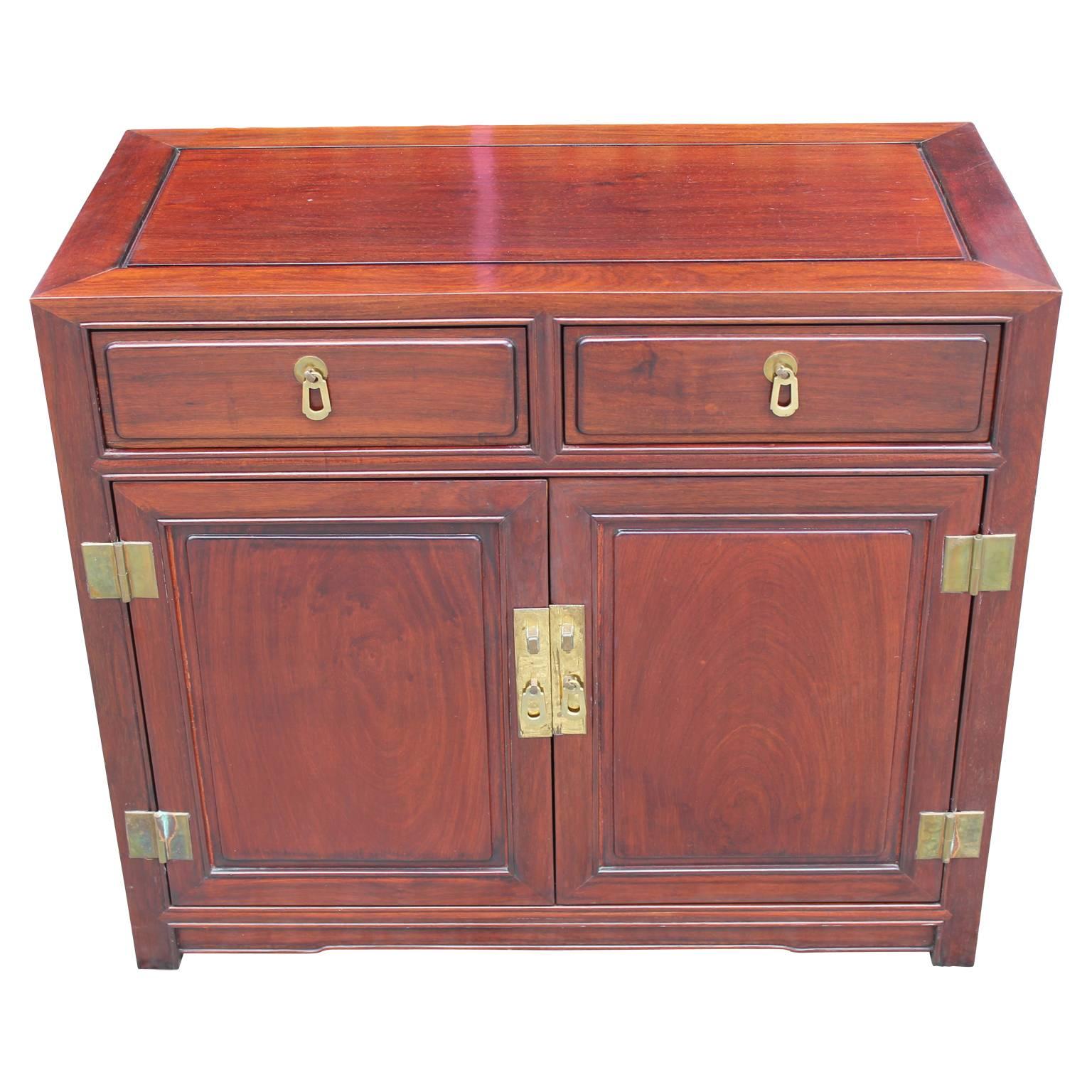 Beautiful Mid-Century Modern small sized chest or cabinet made out of mahogany and fashioned with brass hardware that has a nice patina. In the style of Henredon or Baker Furniture.