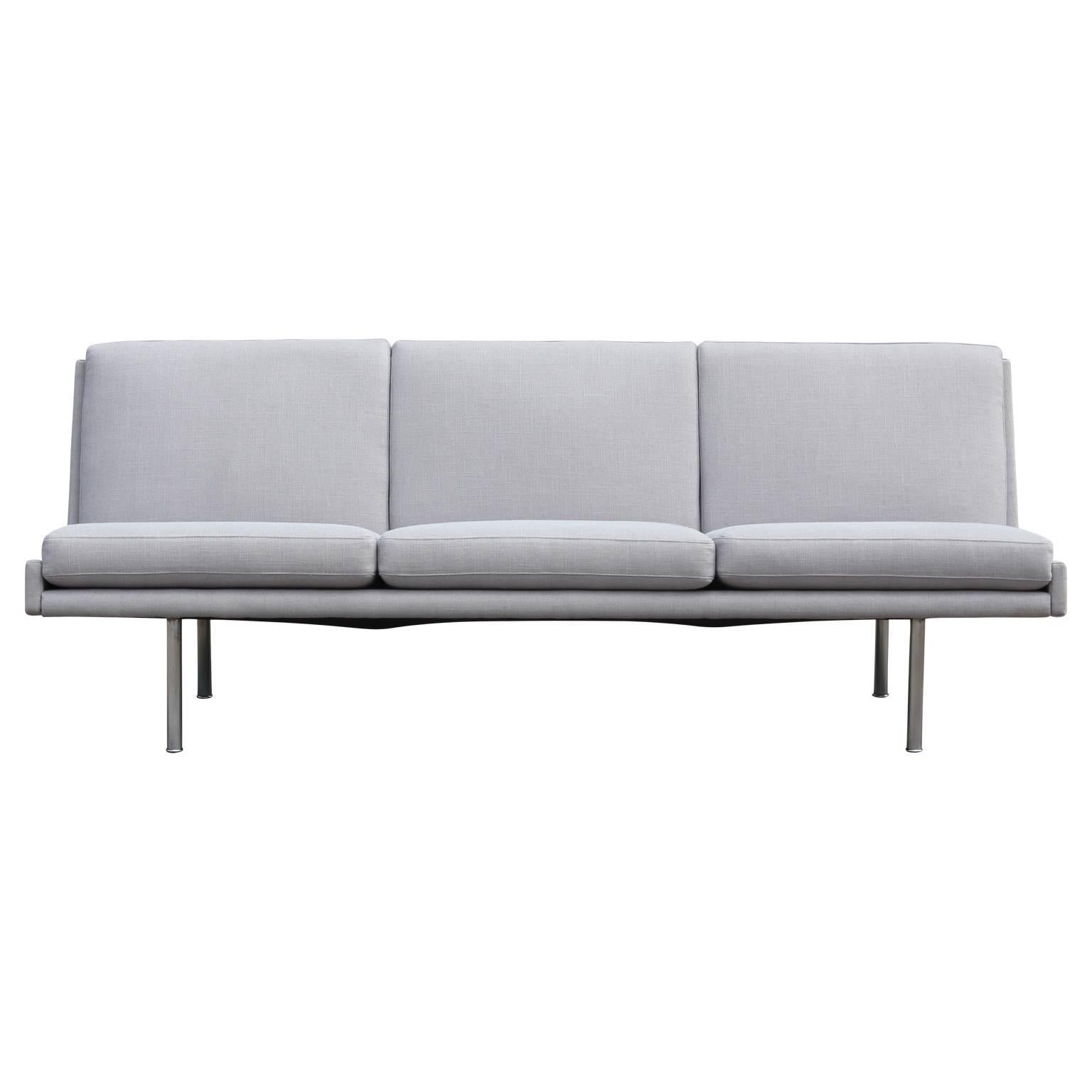 Rare and gorgeous Hans Wegner armless three-seat sofa with tubular steel legs and upholstered in a gorgeous light grey woven Crypton fabric. Very unique.